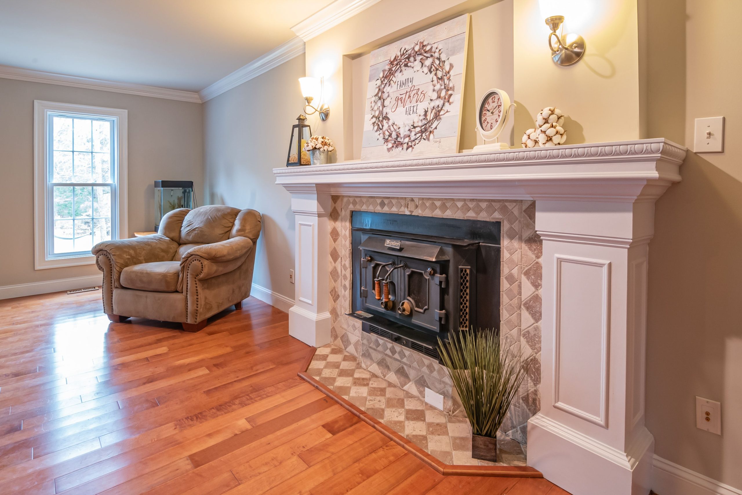 Contemporary living room featuring a comfortable armchair and elegant fireplace with decorative mantel.