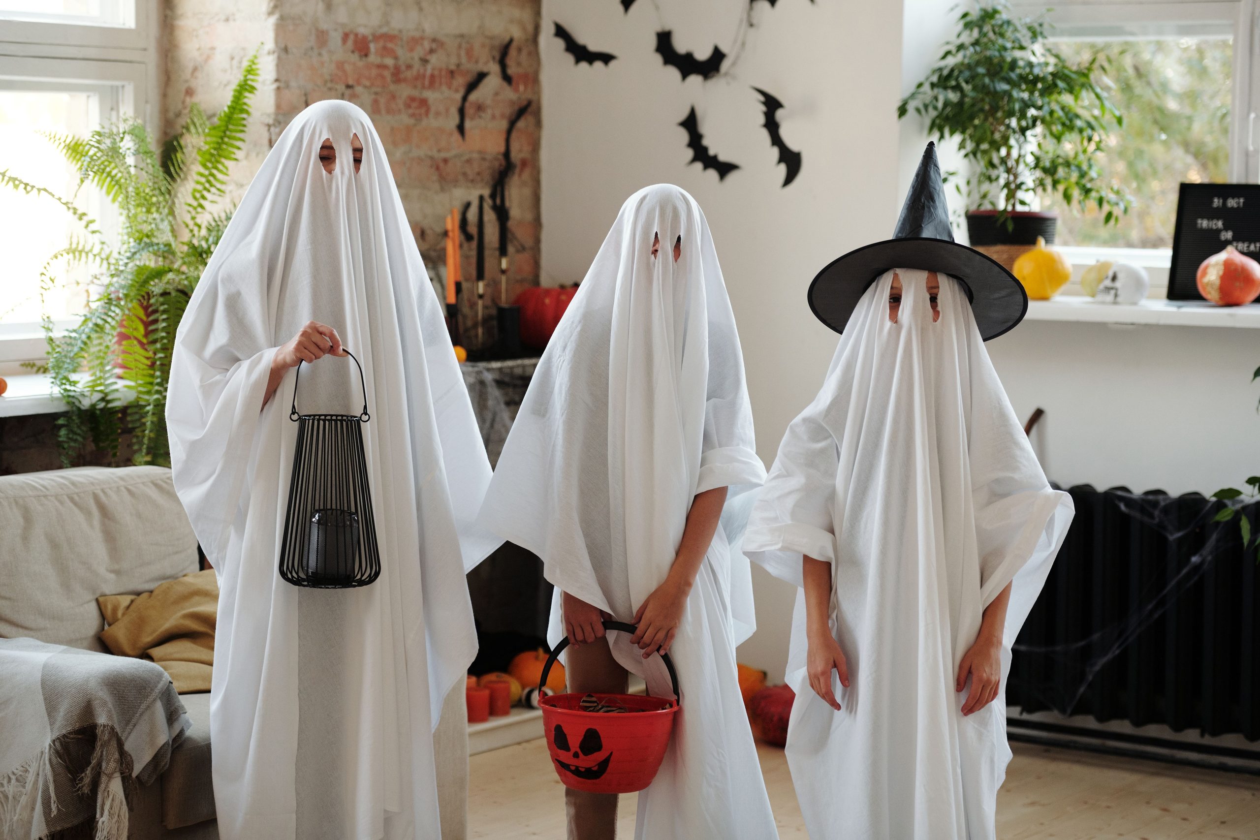 Creative homemade ghost costumes for a fun indoor Halloween celebration.