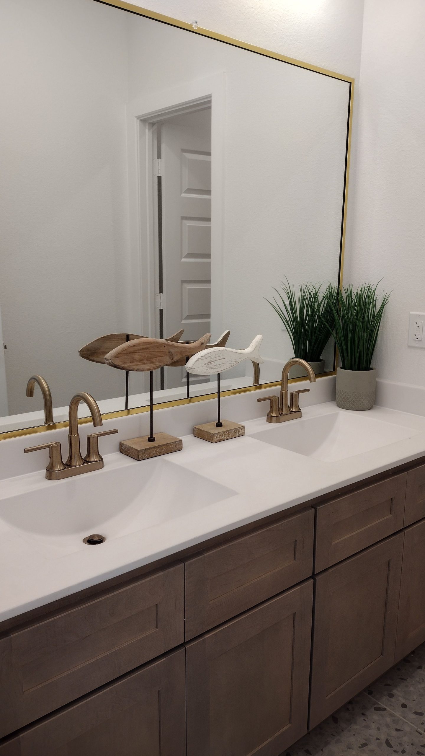 Elegant bathroom vanity with double sinks, stylish faucets, and decorative accents.