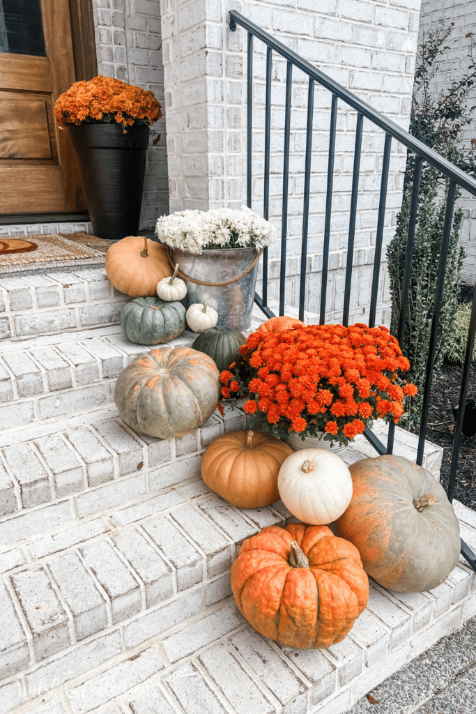 Fall front porch with cascading pumpkins - Wilshire Collections