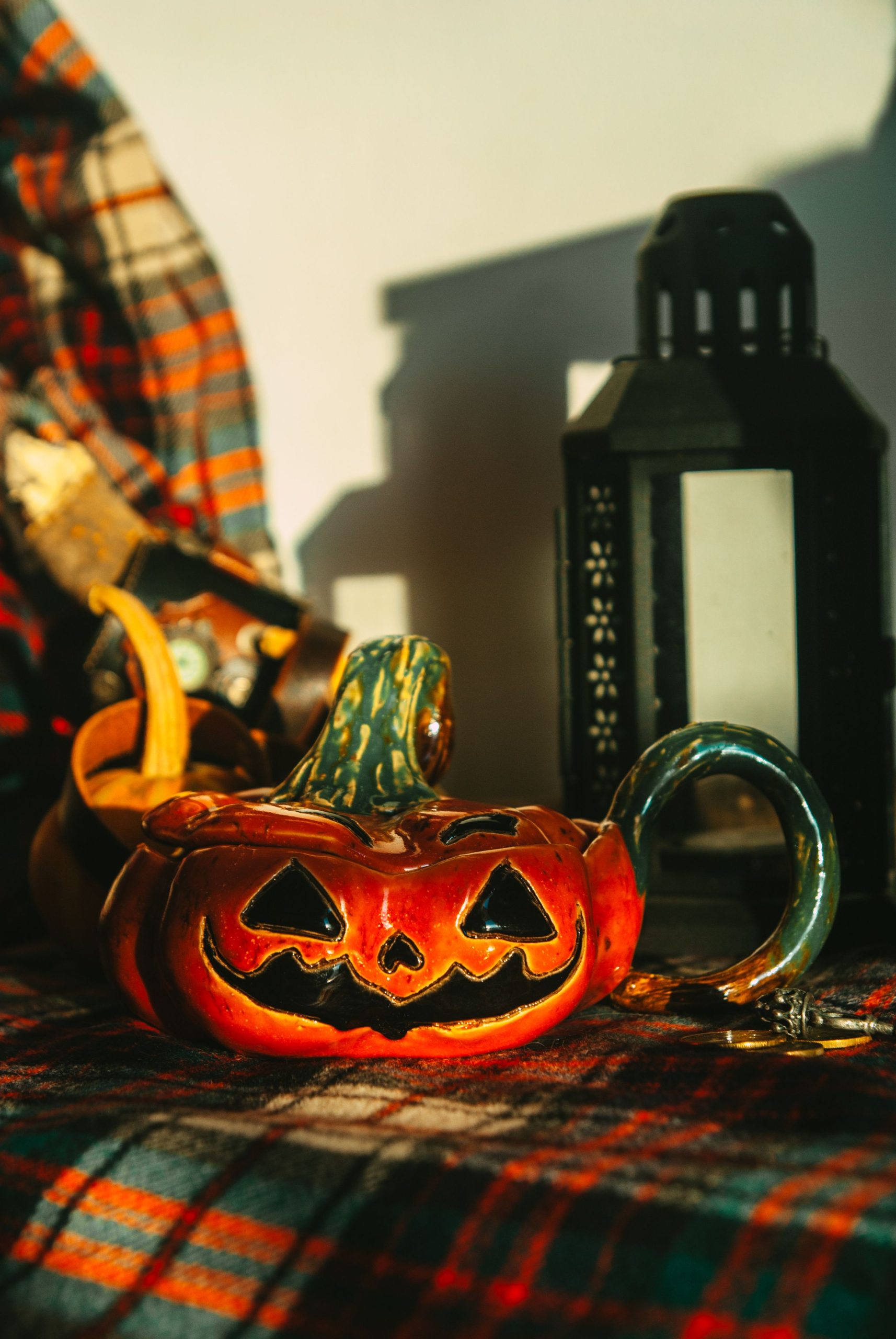 Festive Halloween scene with a jack-o'-lantern and lantern casting shadows.