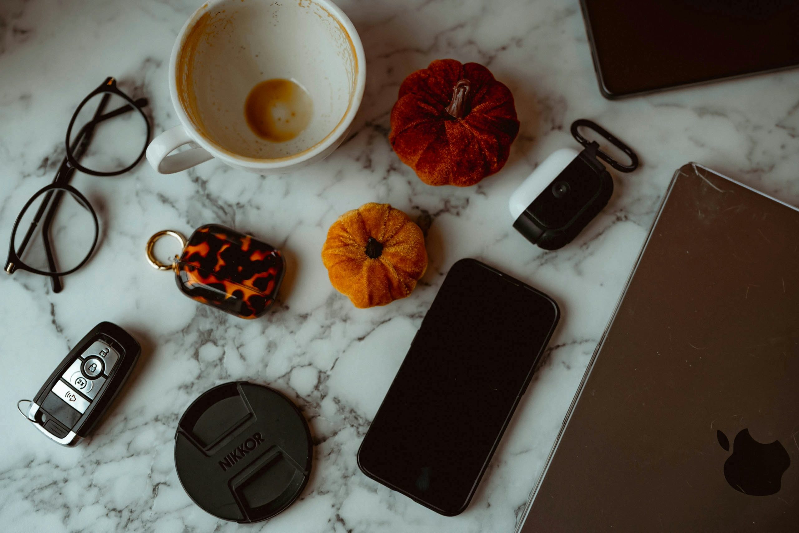 Flat lay of everyday objects on marble surface