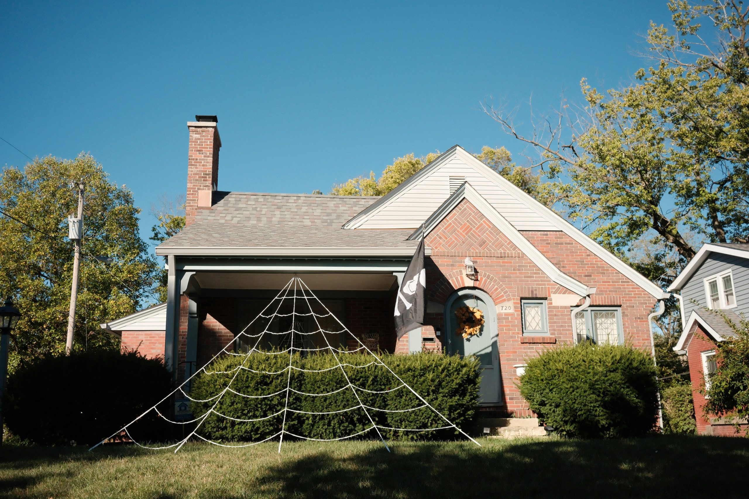 House decorated for halloween with a large spider web