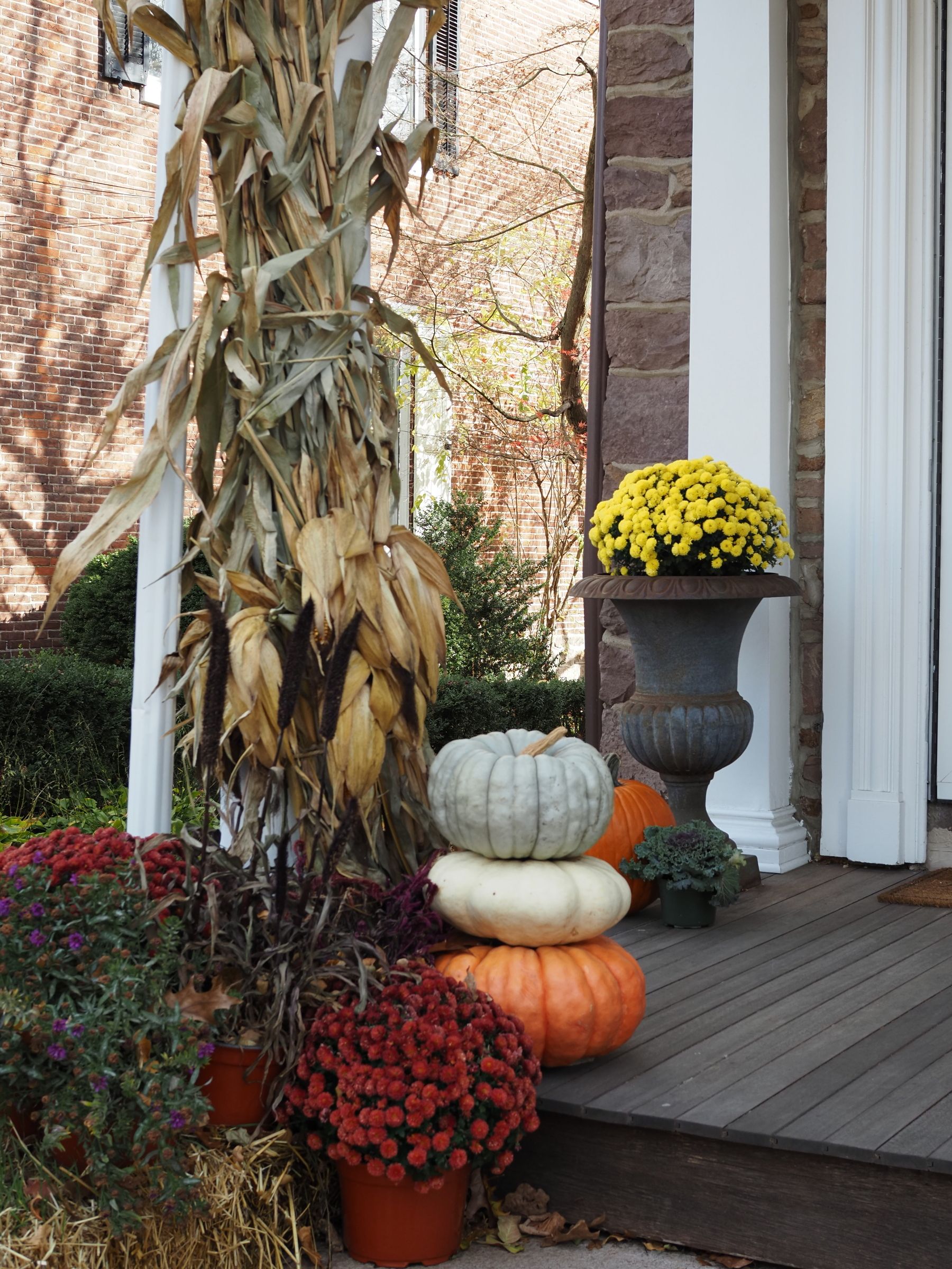 Inviting fall porch with pumpkins and flowers in Doylestown, Pennsylvania.