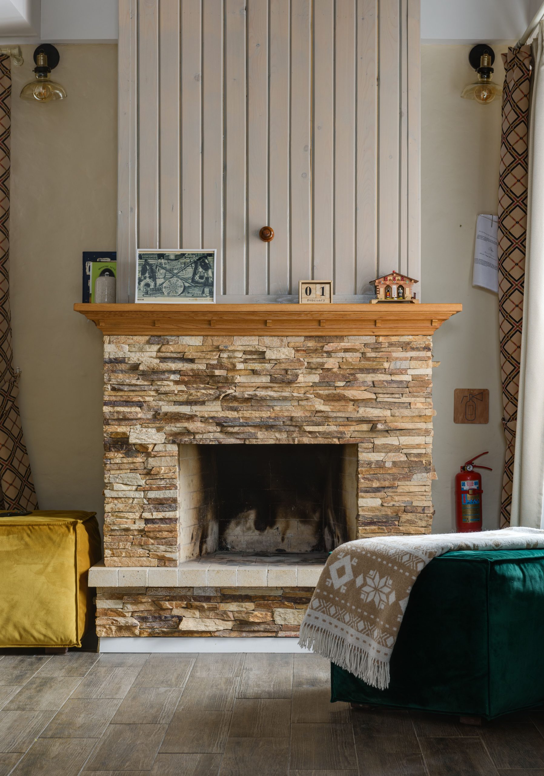 Inviting interior featuring a rustic stone fireplace and charming home decor.