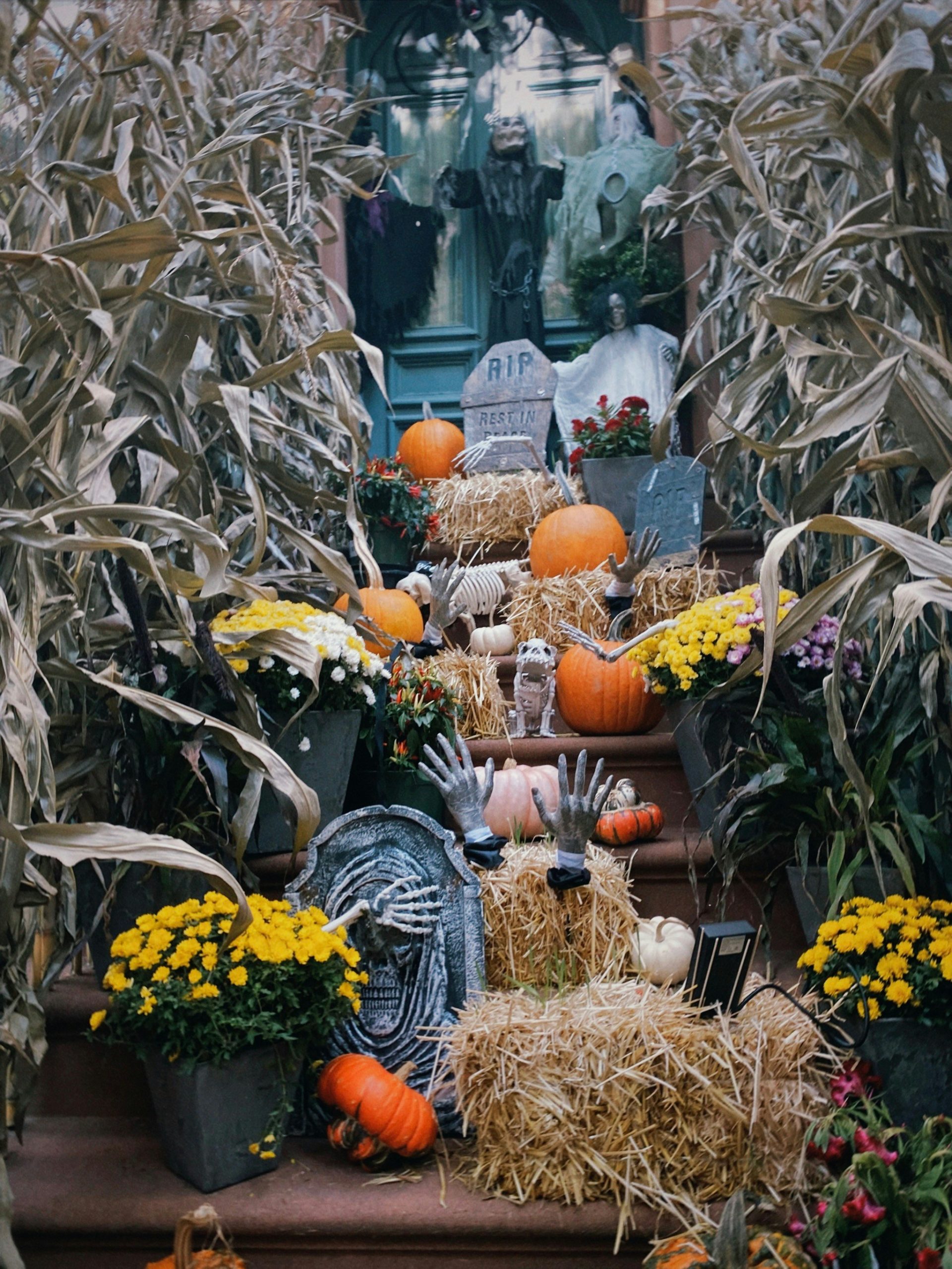 Outdoor decorations for Halloween. Pumpkins and tombstones on the stairs