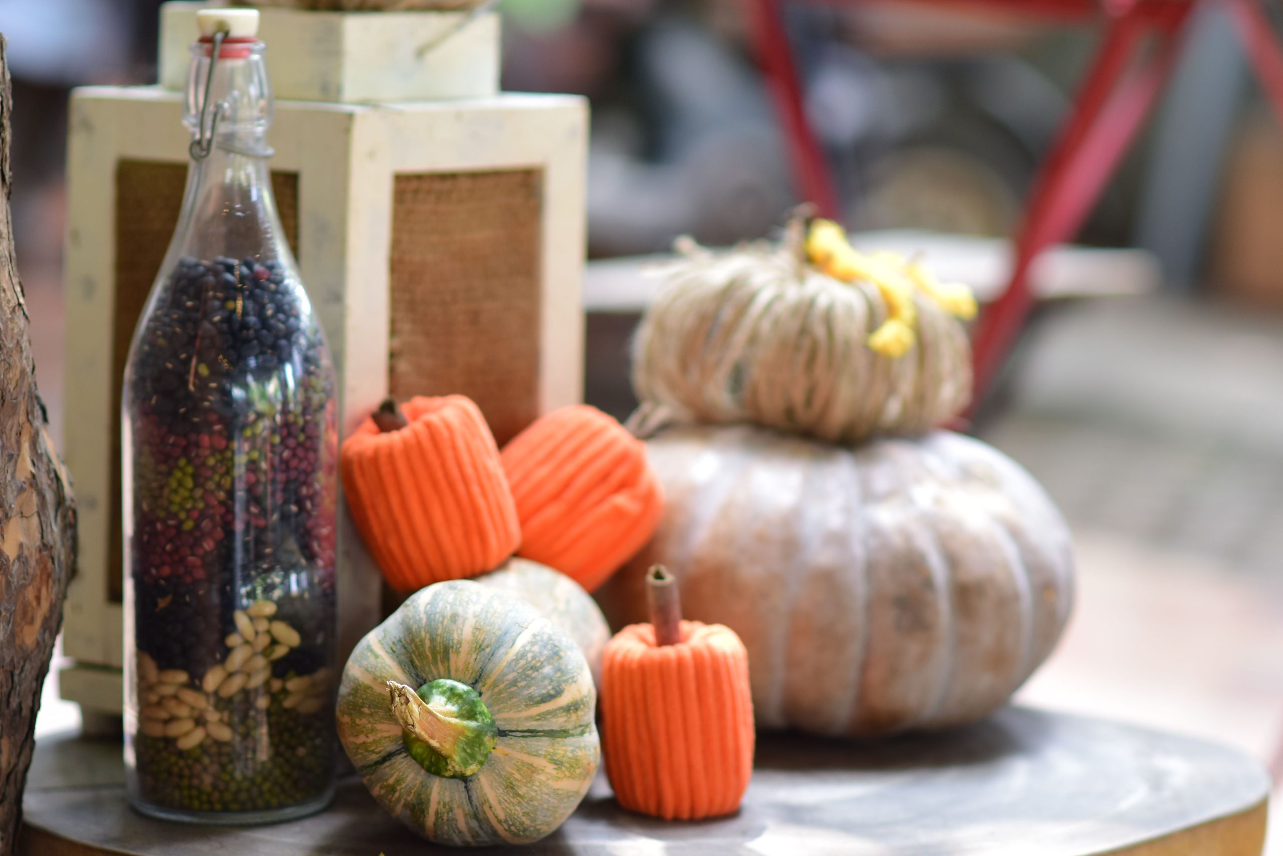 Rustic autumn display with pumpkins and a bottle of seeds, perfect for fall decoration concepts.