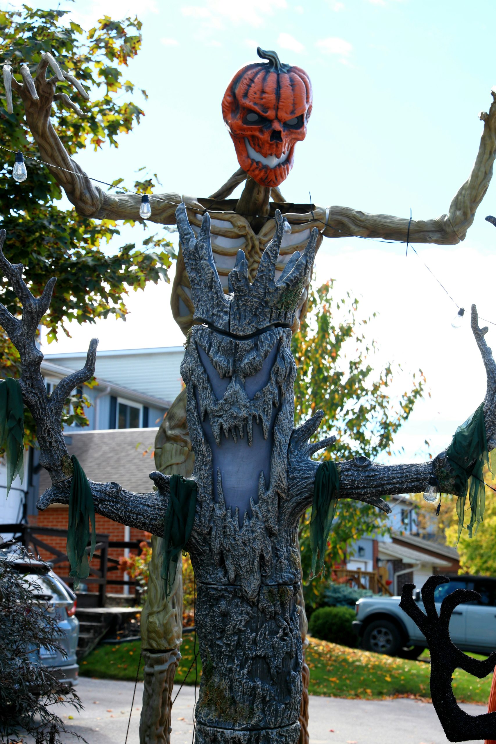 Scary halloween decoration with pumpkin head and tree body