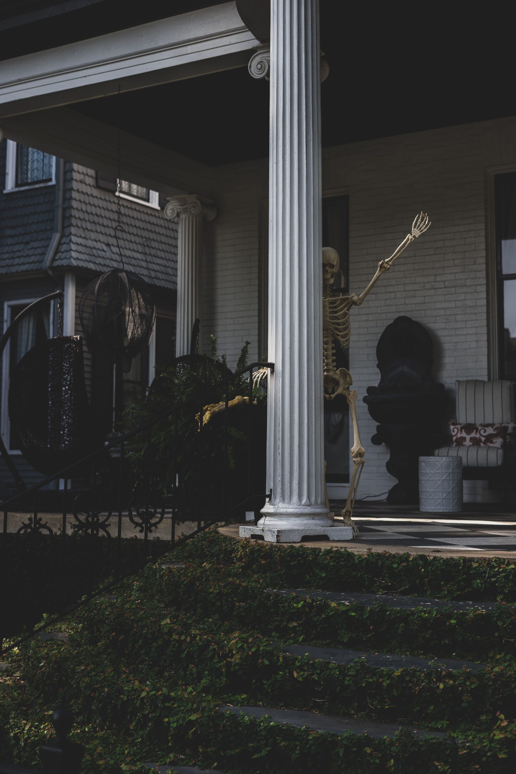 Skeleton decoration on a porch in Greenville, SC, creating a spooky Halloween atmosphere.