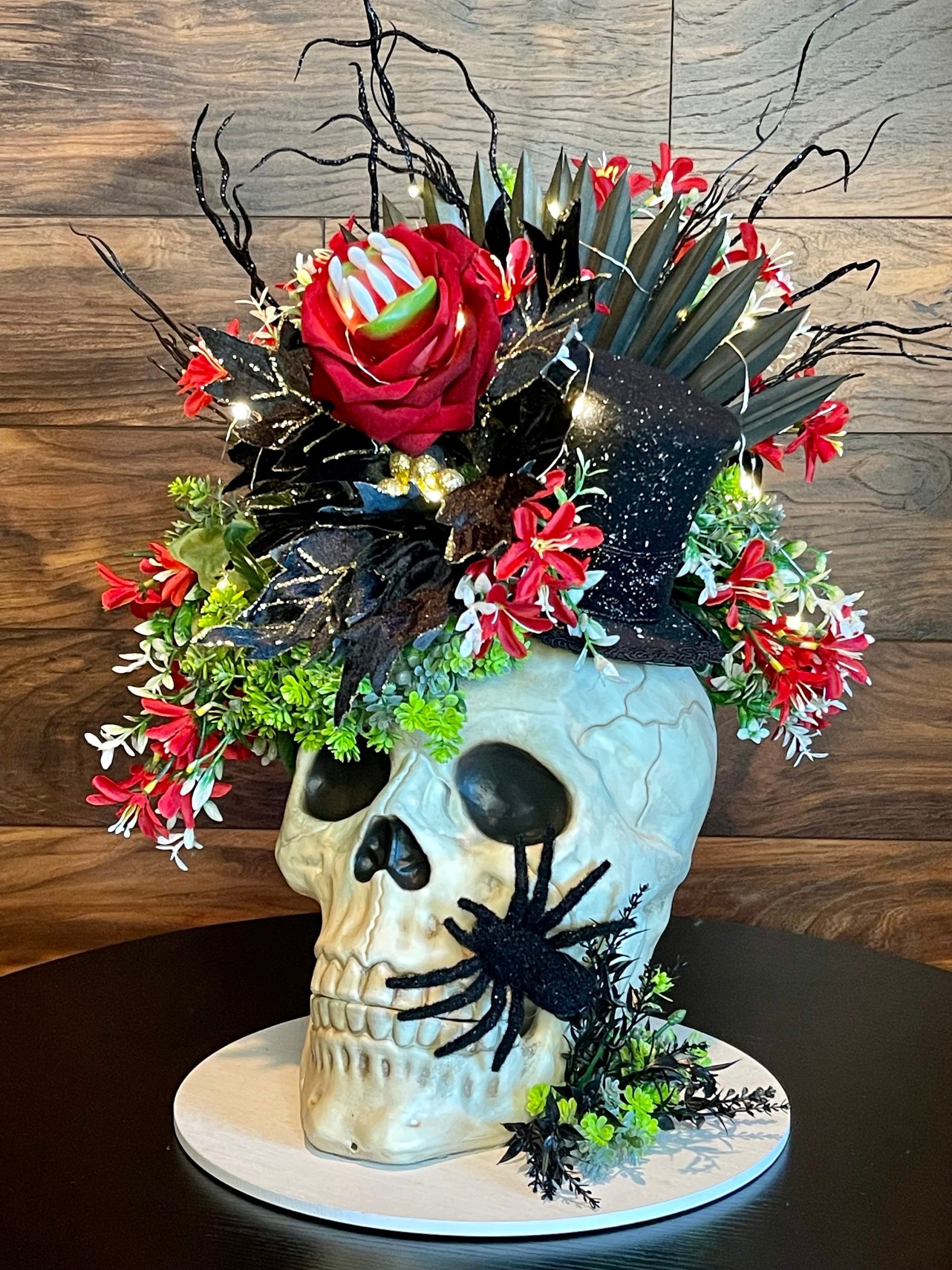 Skull Halloween centerpiece with pumpkins flowers and embellishments