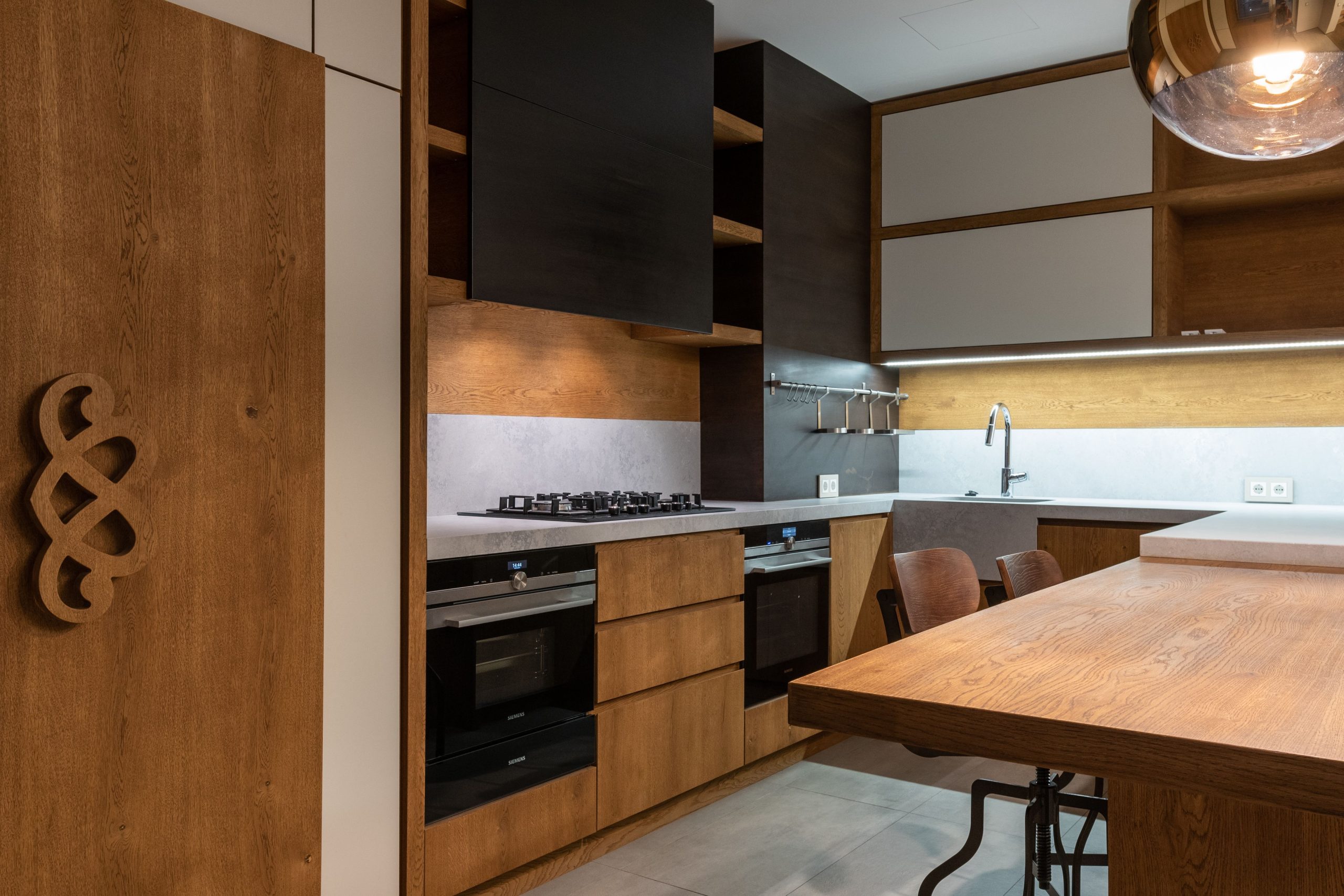 Stylish contemporary kitchen featuring wooden accents and modern appliances.