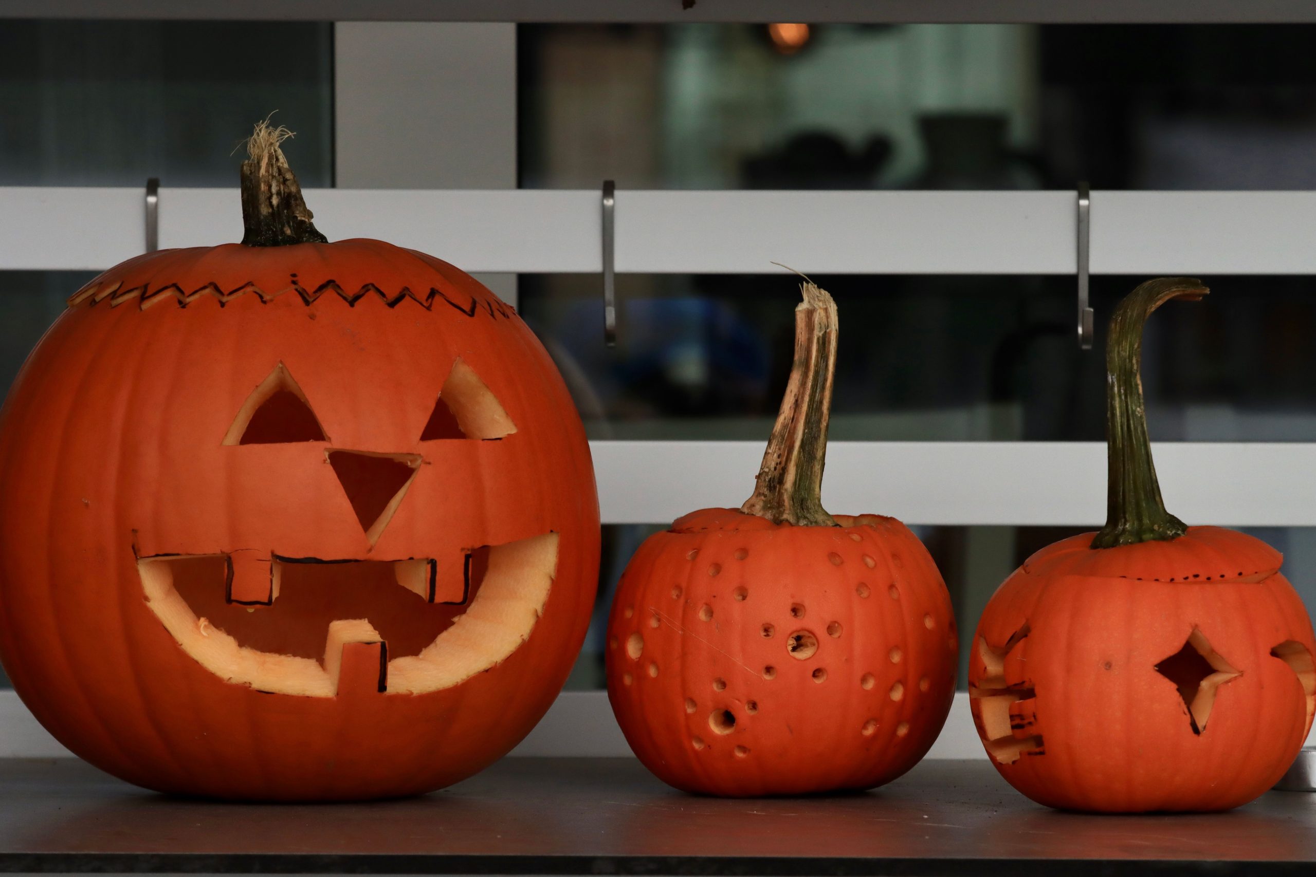 Three carved pumpkins displayed as Halloween decorations in Jönköping, Sweden.