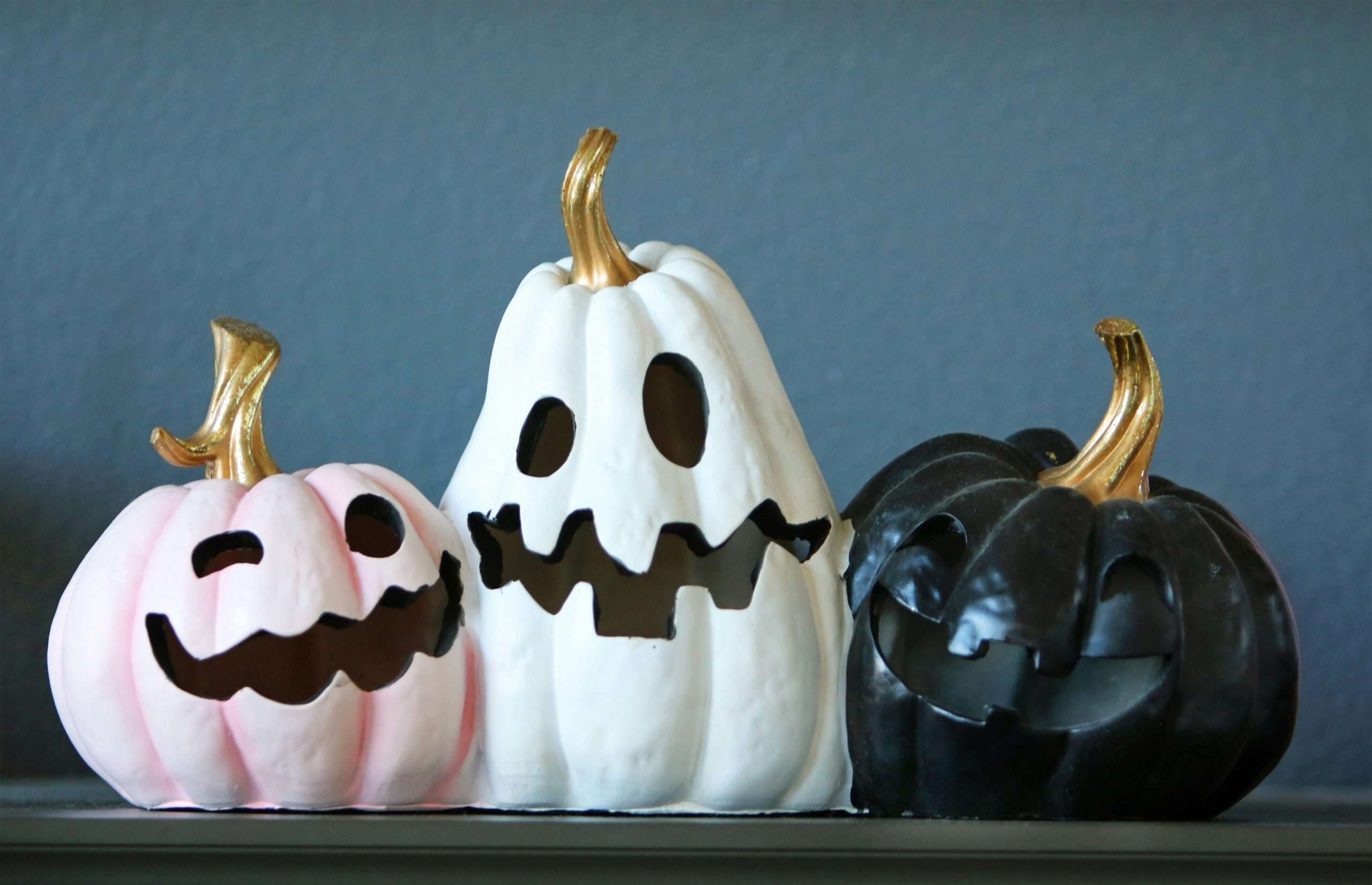 Three decorative halloween pumpkins with carved faces