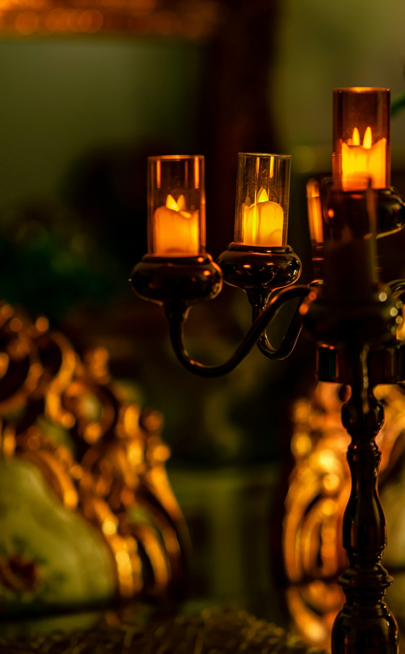 three lit candles sitting on top of a table