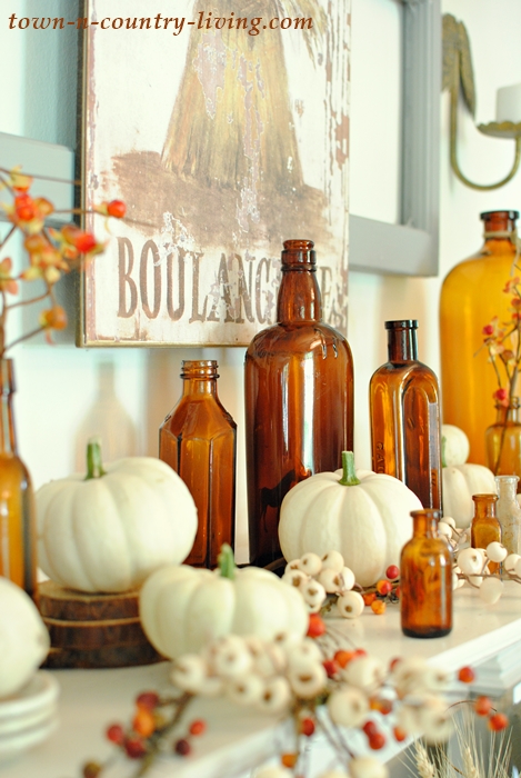 Vintage Fall Mantel with Brown Bottles - Town & Country Living