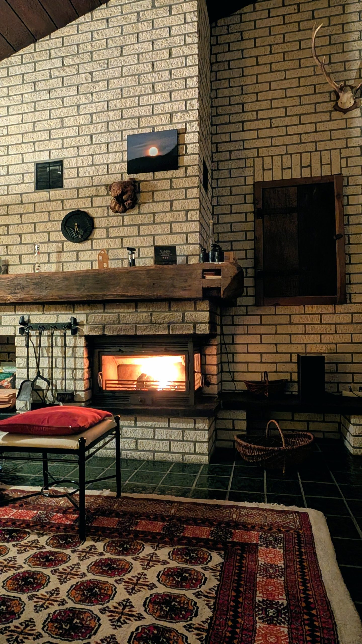 Warm, inviting living room featuring a lit fireplace and rustic decor for a cozy ambiance.