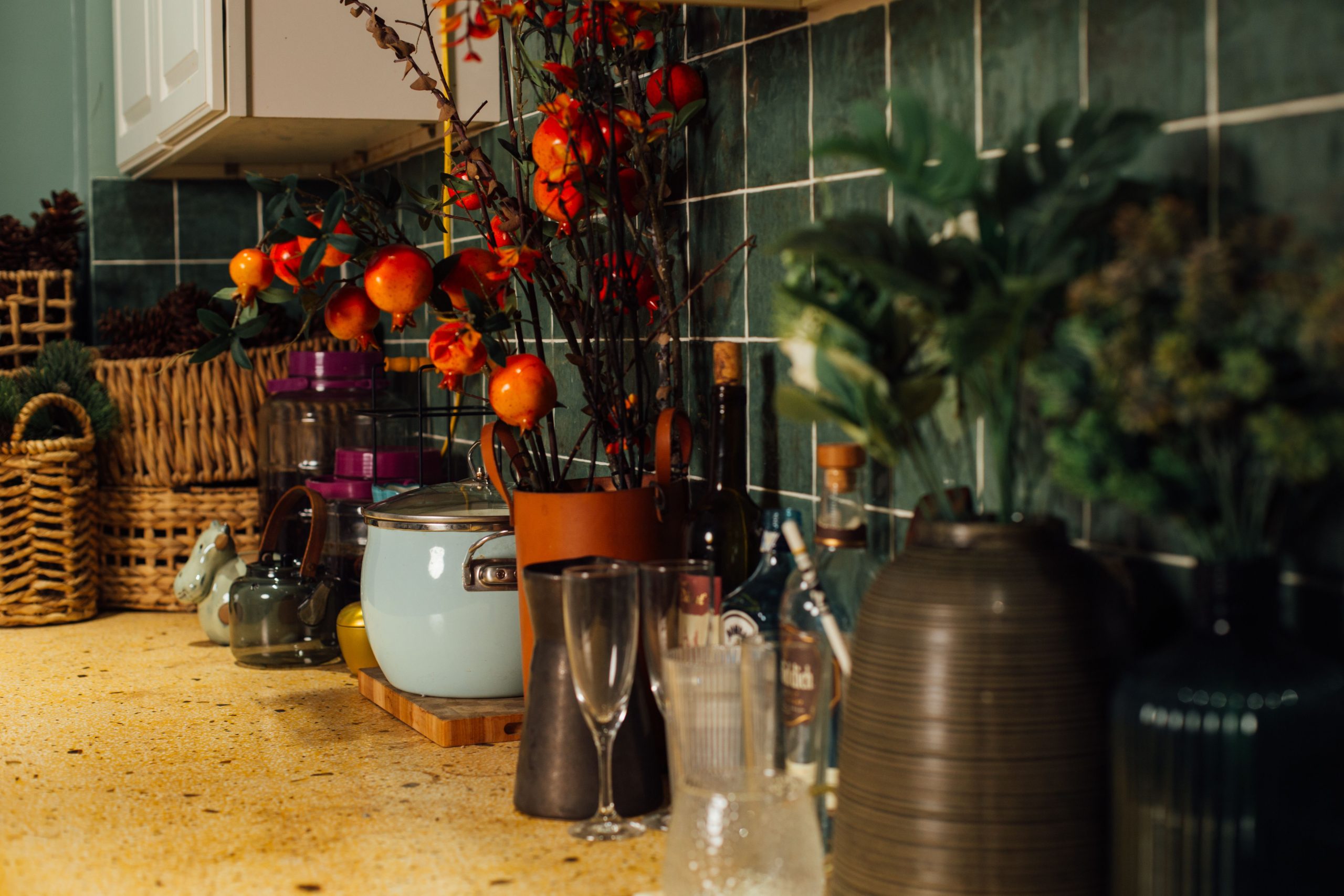 Warm kitchen counter adorned with plants and autumn-themed decor.