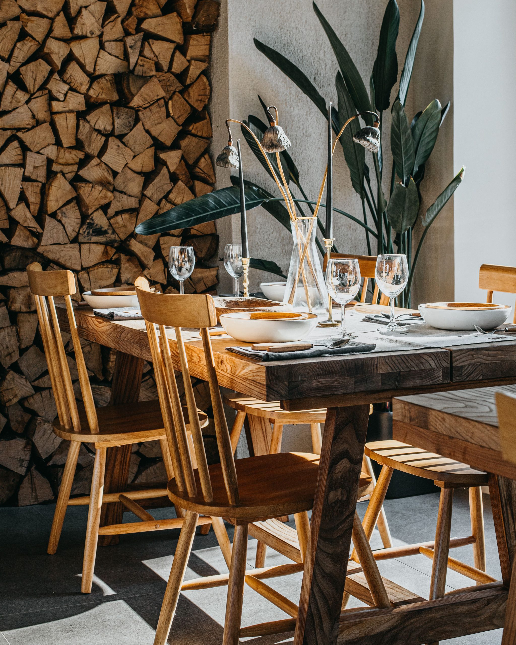 Warmly lit rustic dining setup with wooden furniture and decorative elements.