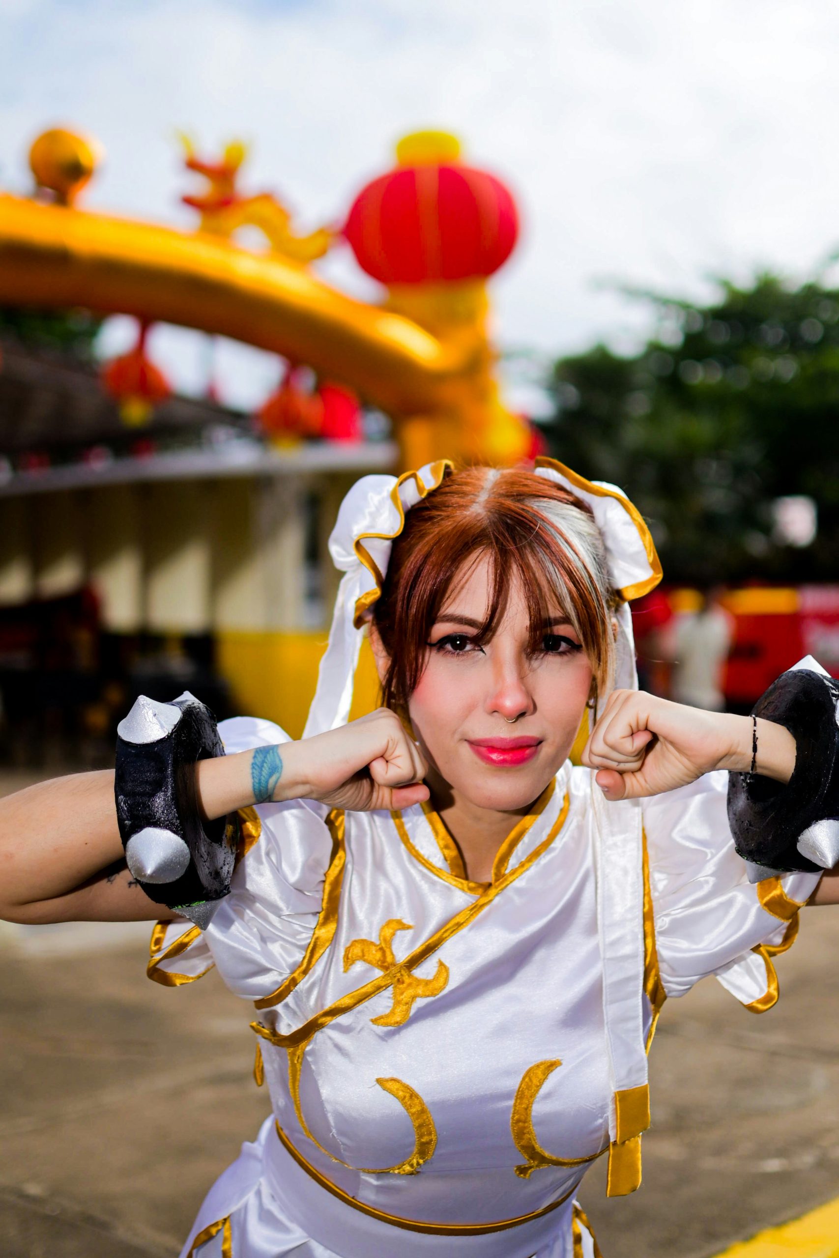 Woman in chun-li costume poses with fists up
