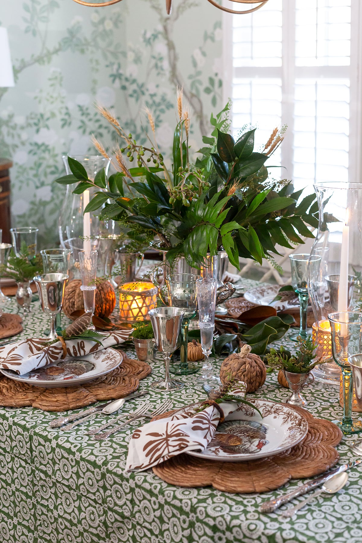 A Collected Green Thanksgiving Table with Rattan and Silver Touches - Pizzazzerie