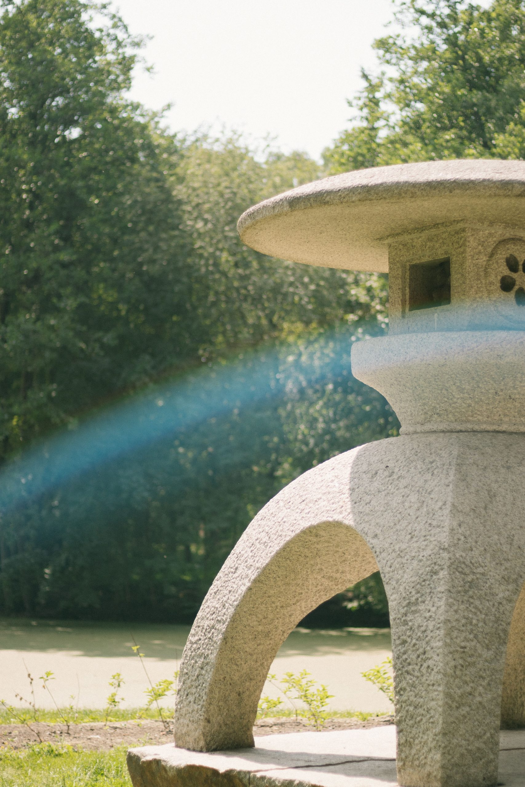 A picturesque stone lantern set amidst lush greenery in a tranquil outdoor garden.