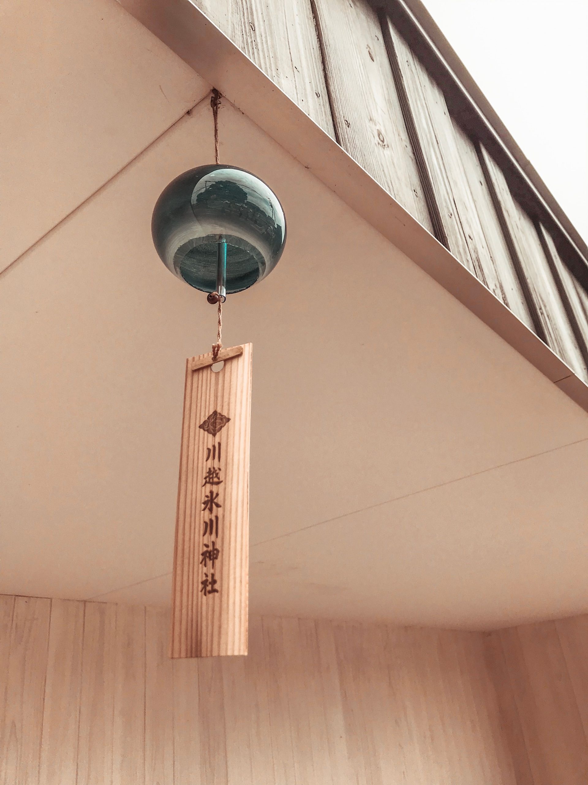 A serene image of a traditional Japanese wind chime hanging at Hikawa Shrine, Japan.