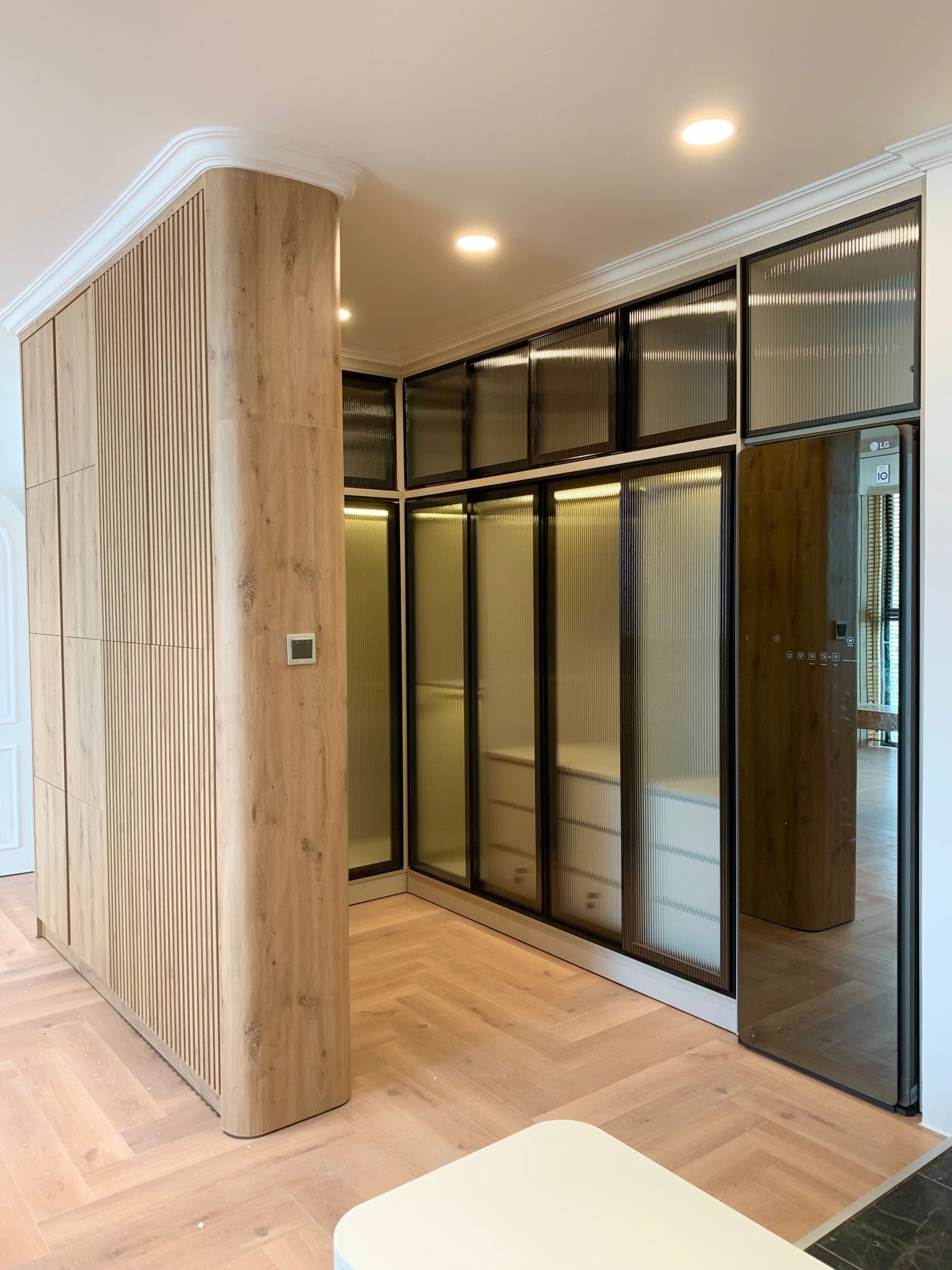 A sleek modern interior with wooden paneling and minimalist glass partitions.