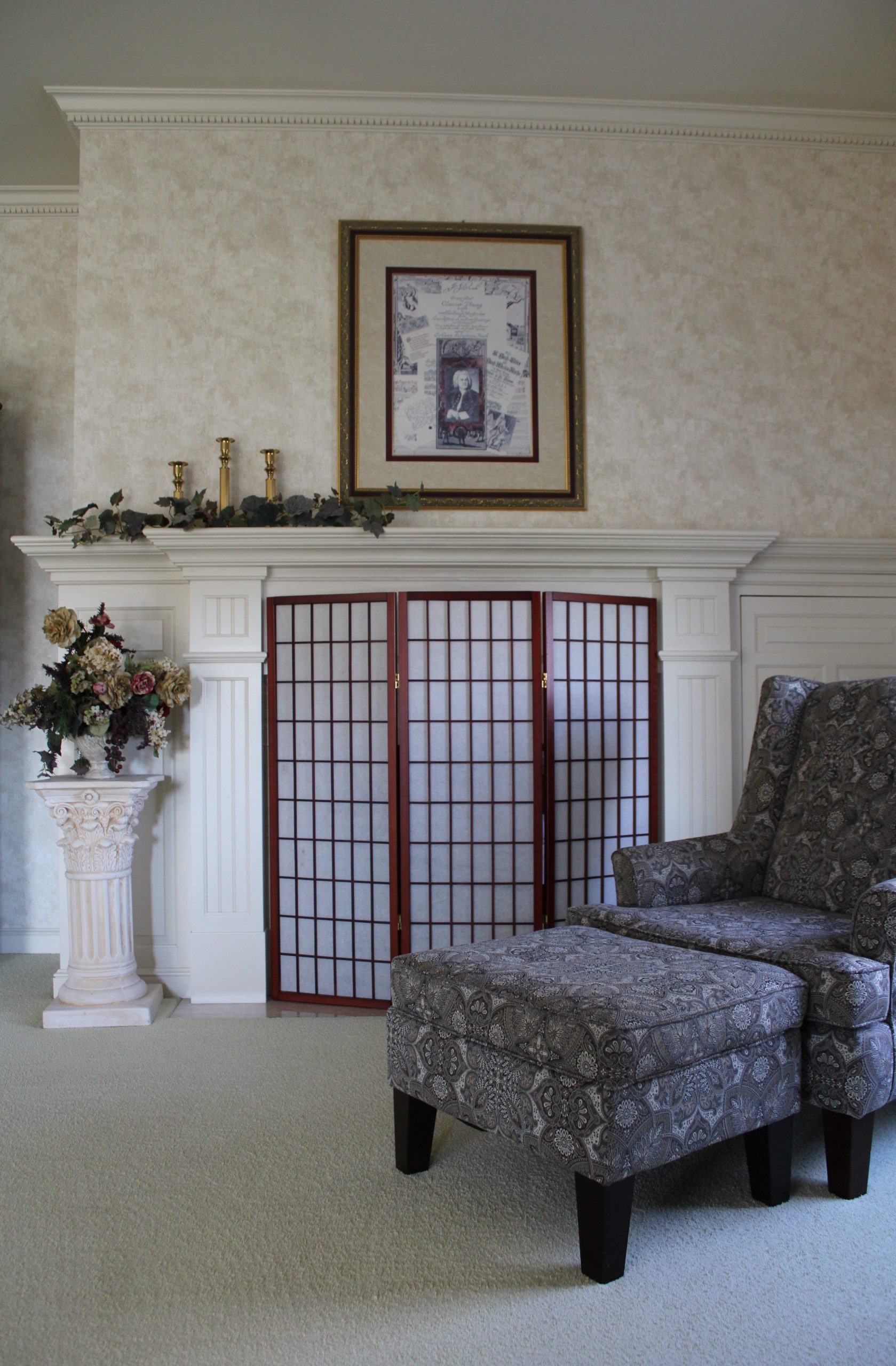 A sophisticated living room setup featuring a fireplace and elegant floral arrangement.