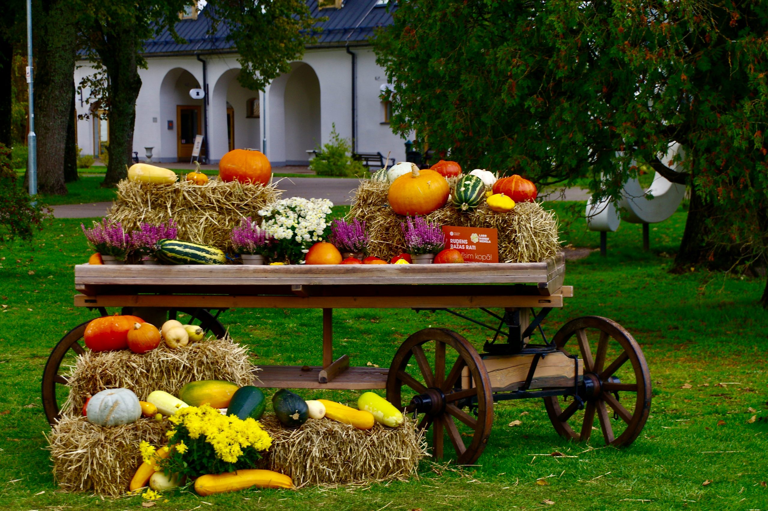 a wagon filled with hay filled with fruits and vegetables
