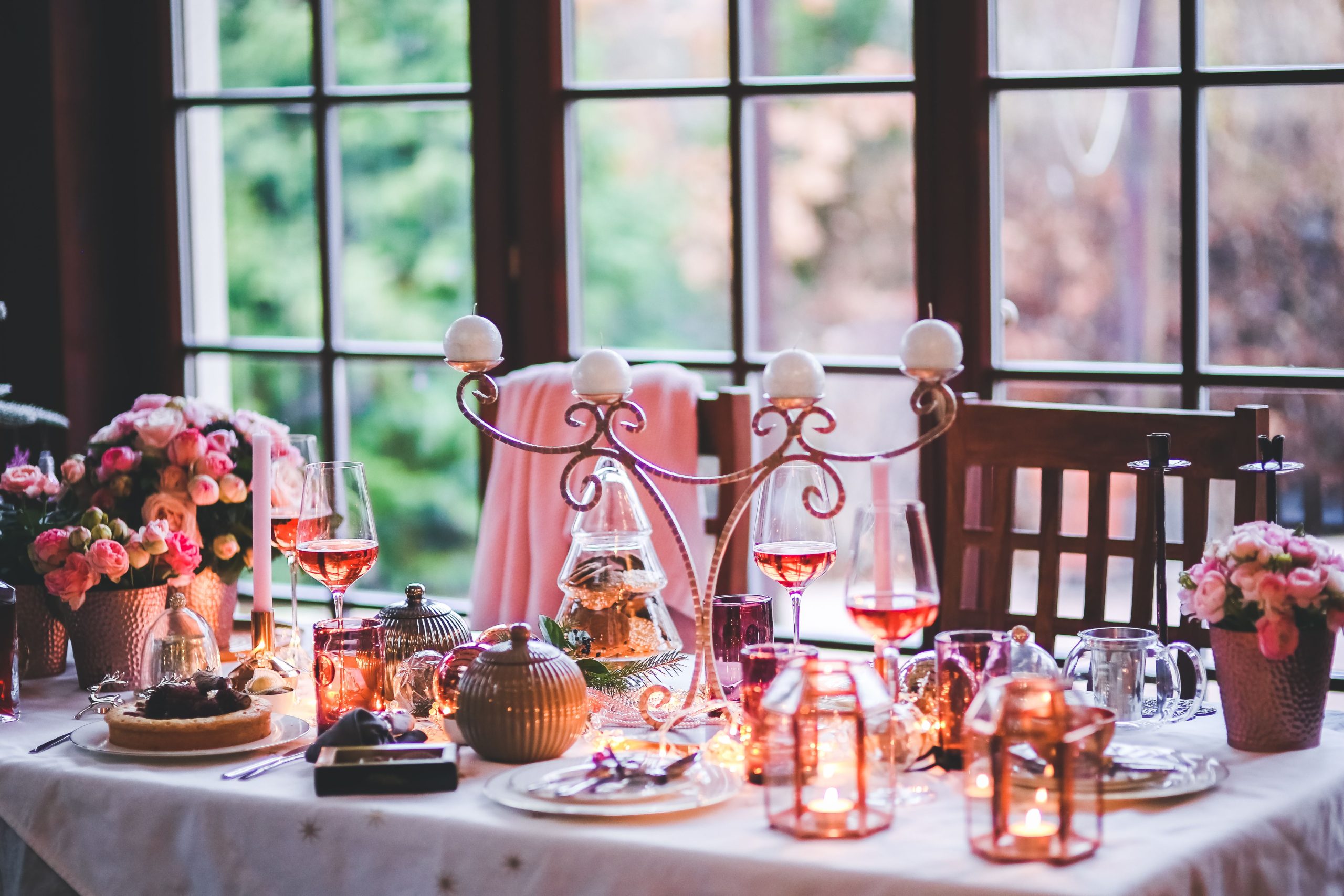 Beautifully set dining table with candles, flowers, and festive decor, perfect for a holiday celebration.