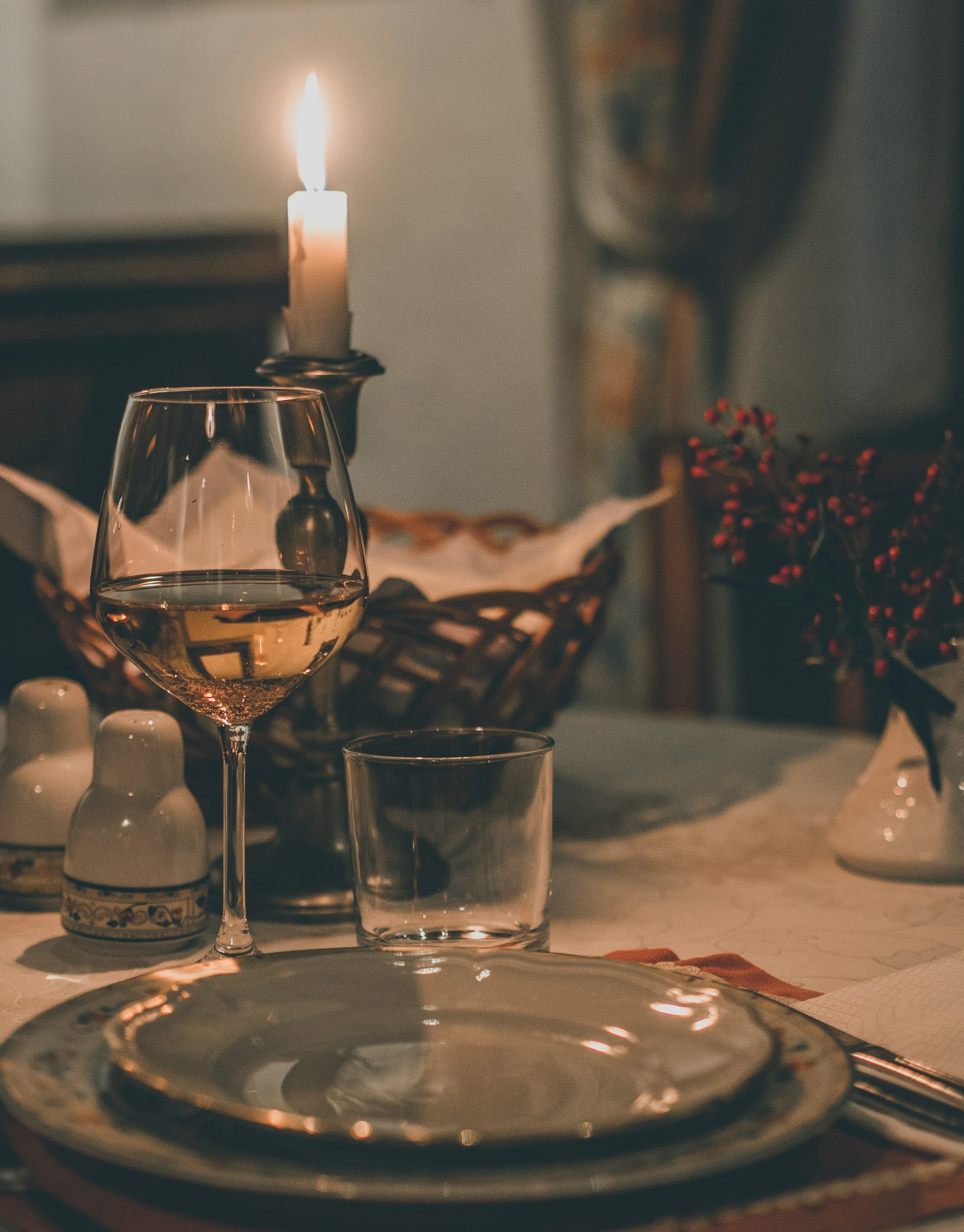 Festive table with candle, warm light, elegant decor