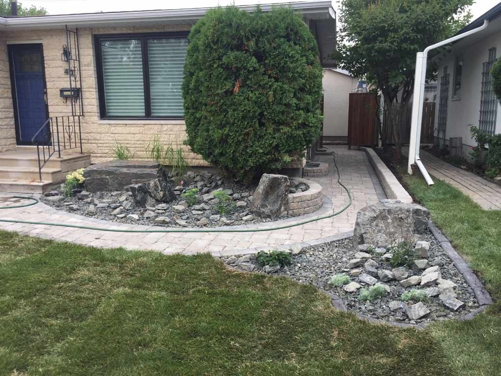 Front Yard Makeover with Roman Paver walk, Black Granite Boulders, Plants, Sod | The Lawn Salon