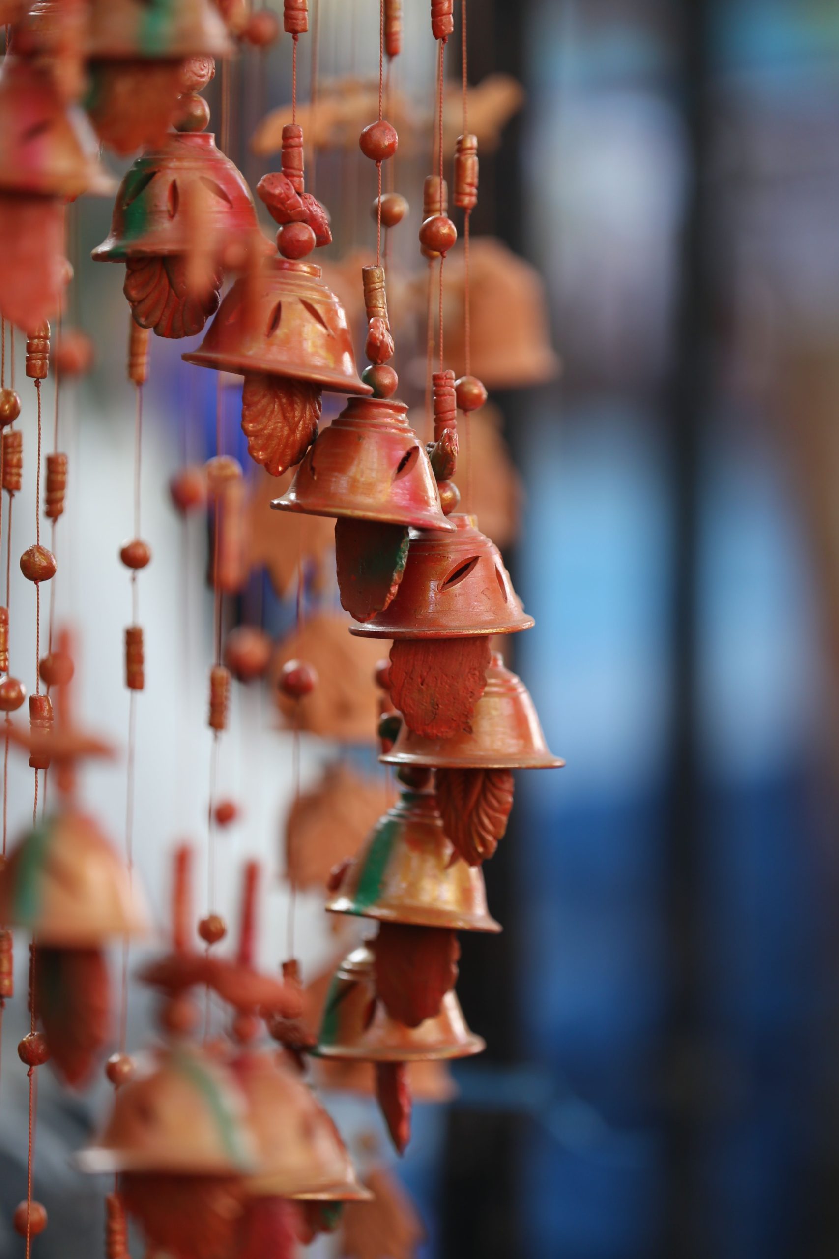 Handmade clay wind chimes hanging, showcasing traditional Indian decor. Captured outdoors in Bengaluru, India.