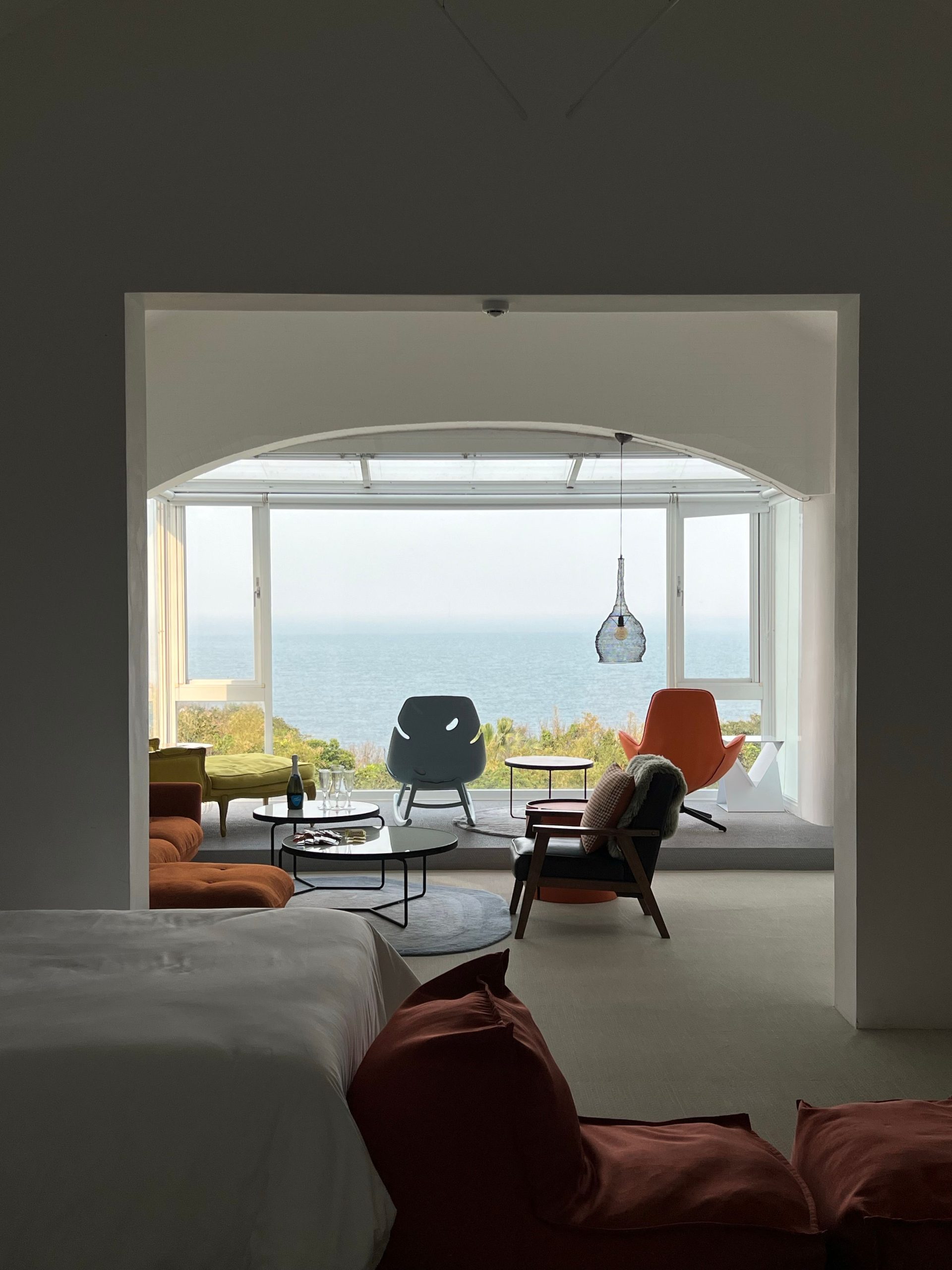 Modern room with ocean view, minimalist decor, and contemporary furniture.