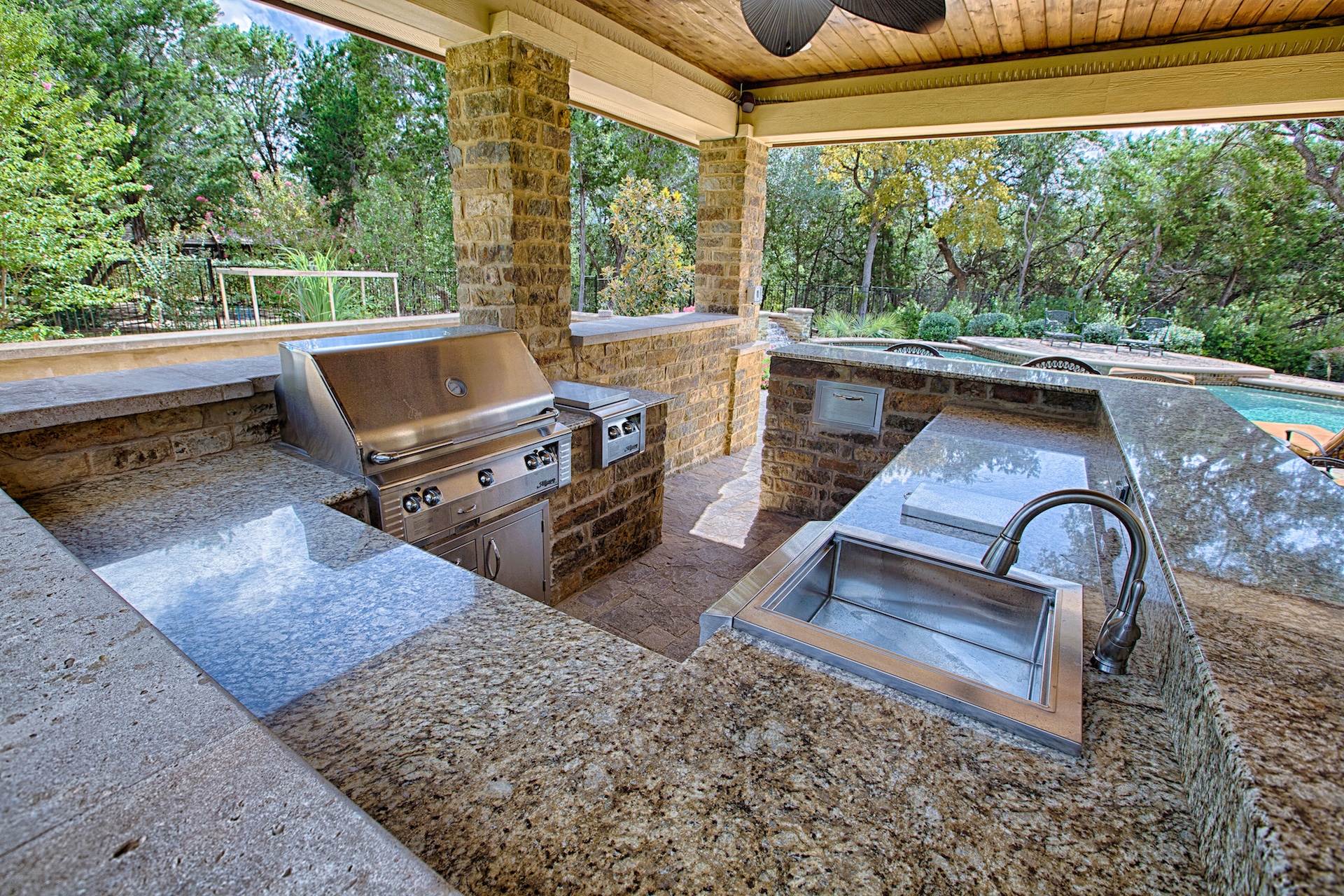 outdoor kitchen with sink, grill, sideburner, refrigerator, trash slide - Spindler Construction - Austin Texas and surrounding areas