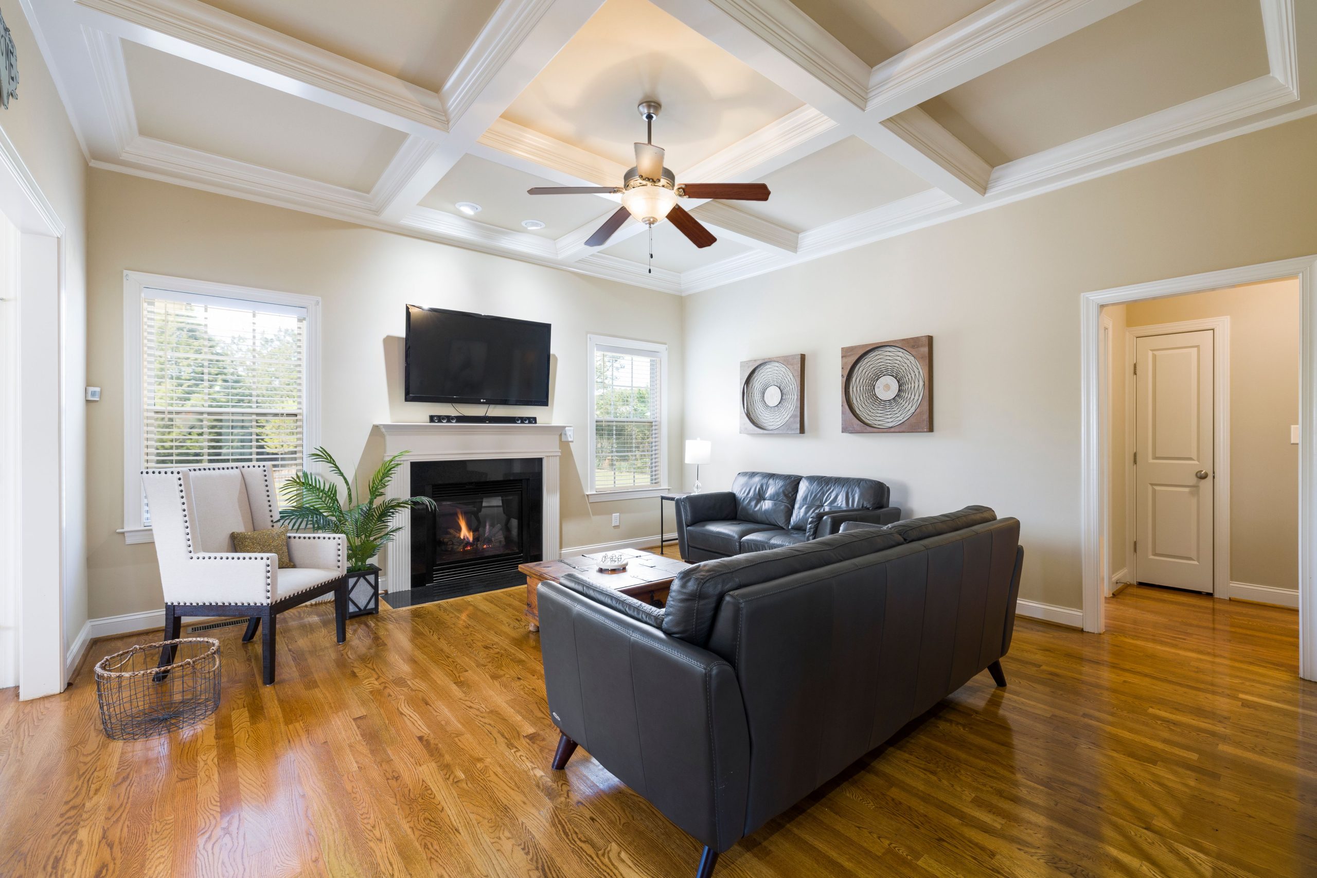 Spacious living room featuring a cozy fireplace, modern furnishings, and a flat screen TV.