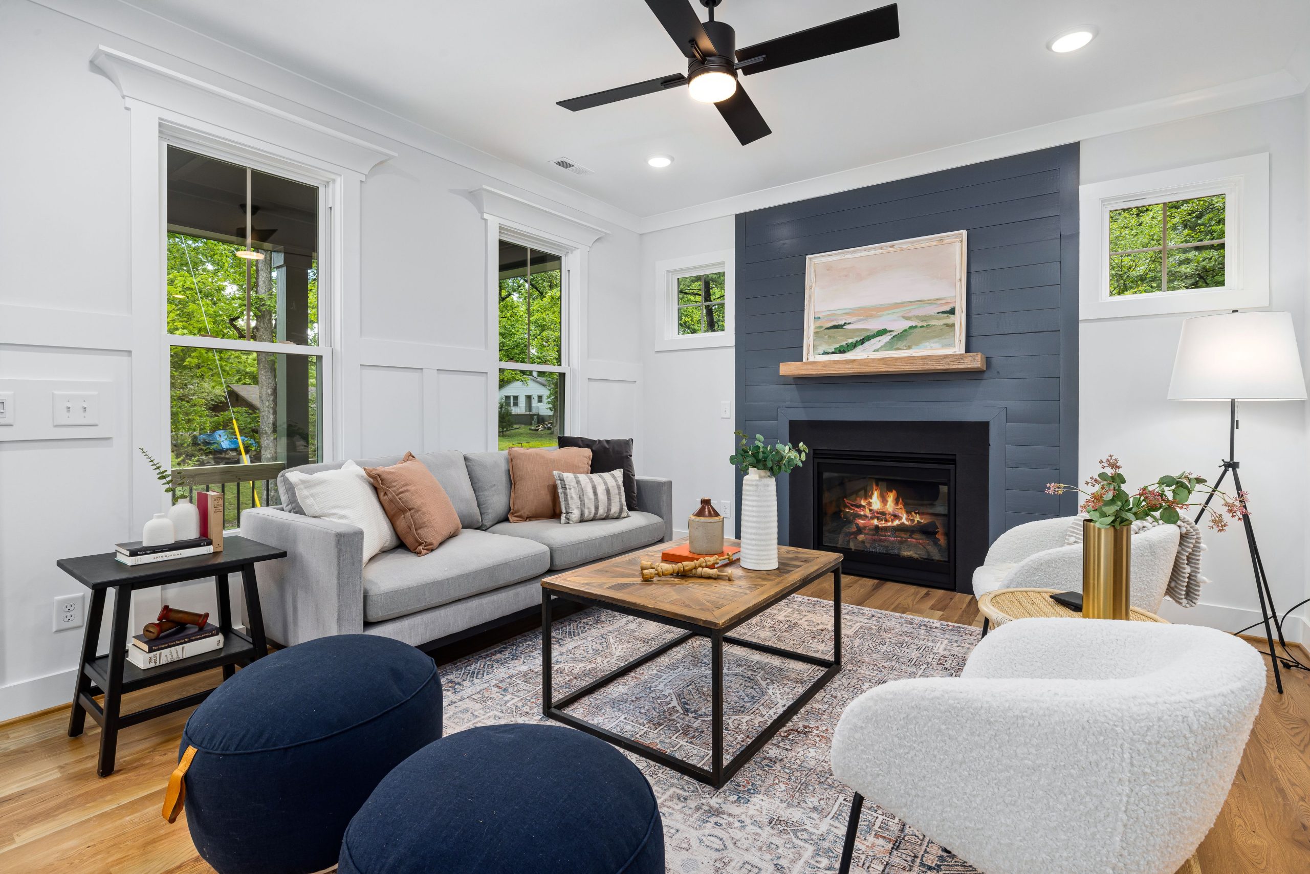 Stylish modern living room with a cozy fireplace, elegant decor, and comfortable seating.