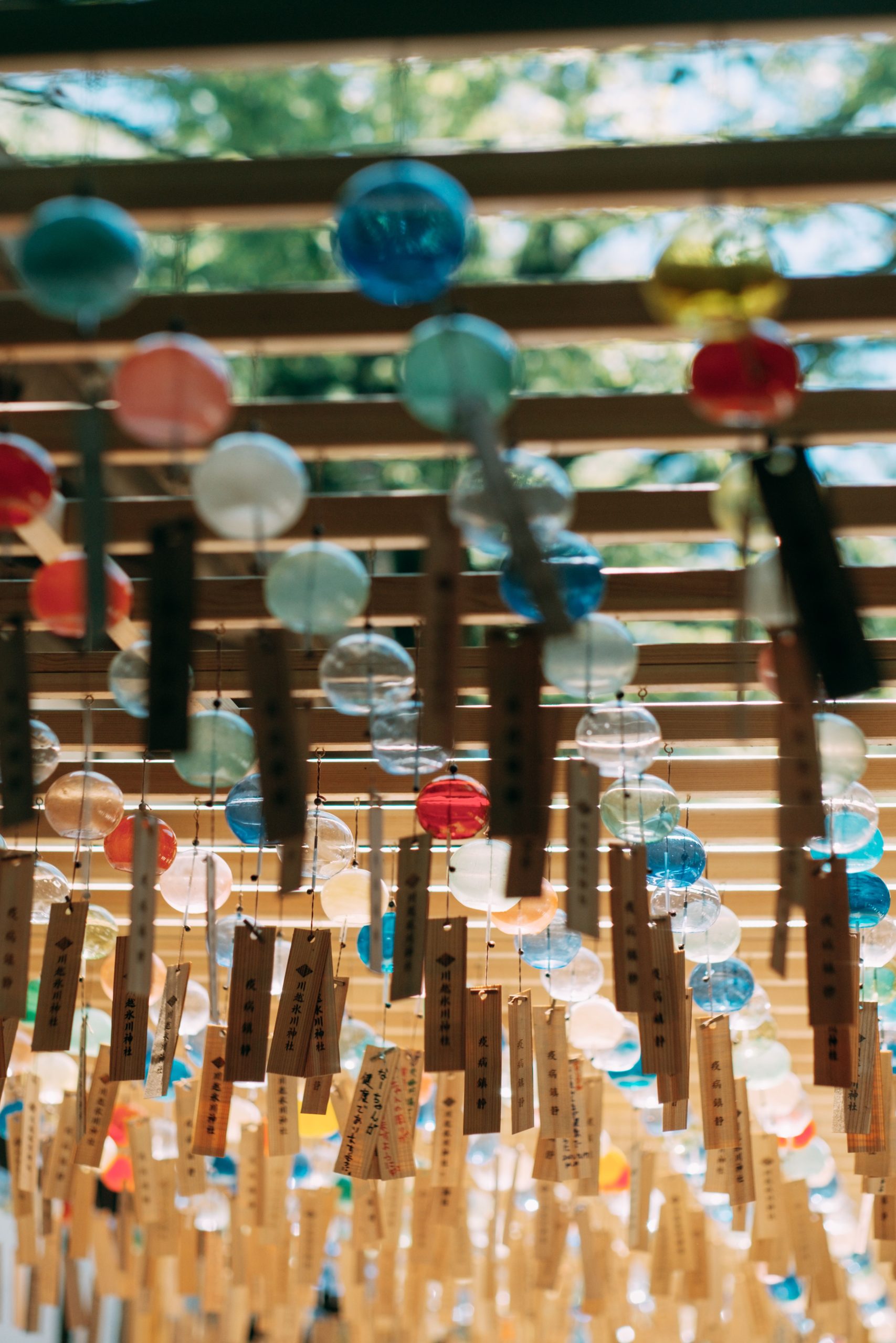 Traditional glass wind chimes hanging at Hikawa Shrine in Kawagoe, Japan, vibrant and cultural.