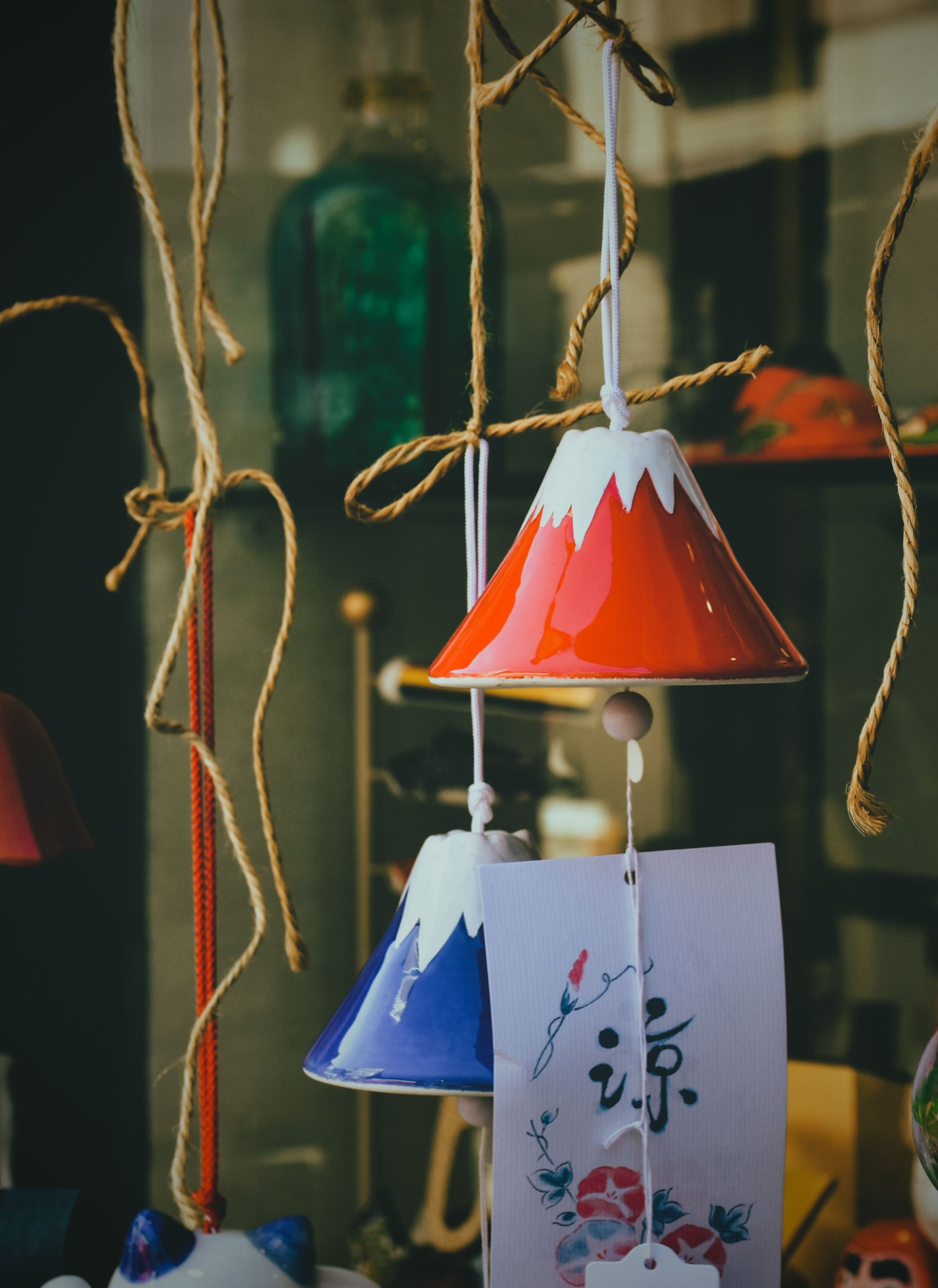 Vibrant ceramic wind chimes with Asian motifs, perfect for artistic decoration.