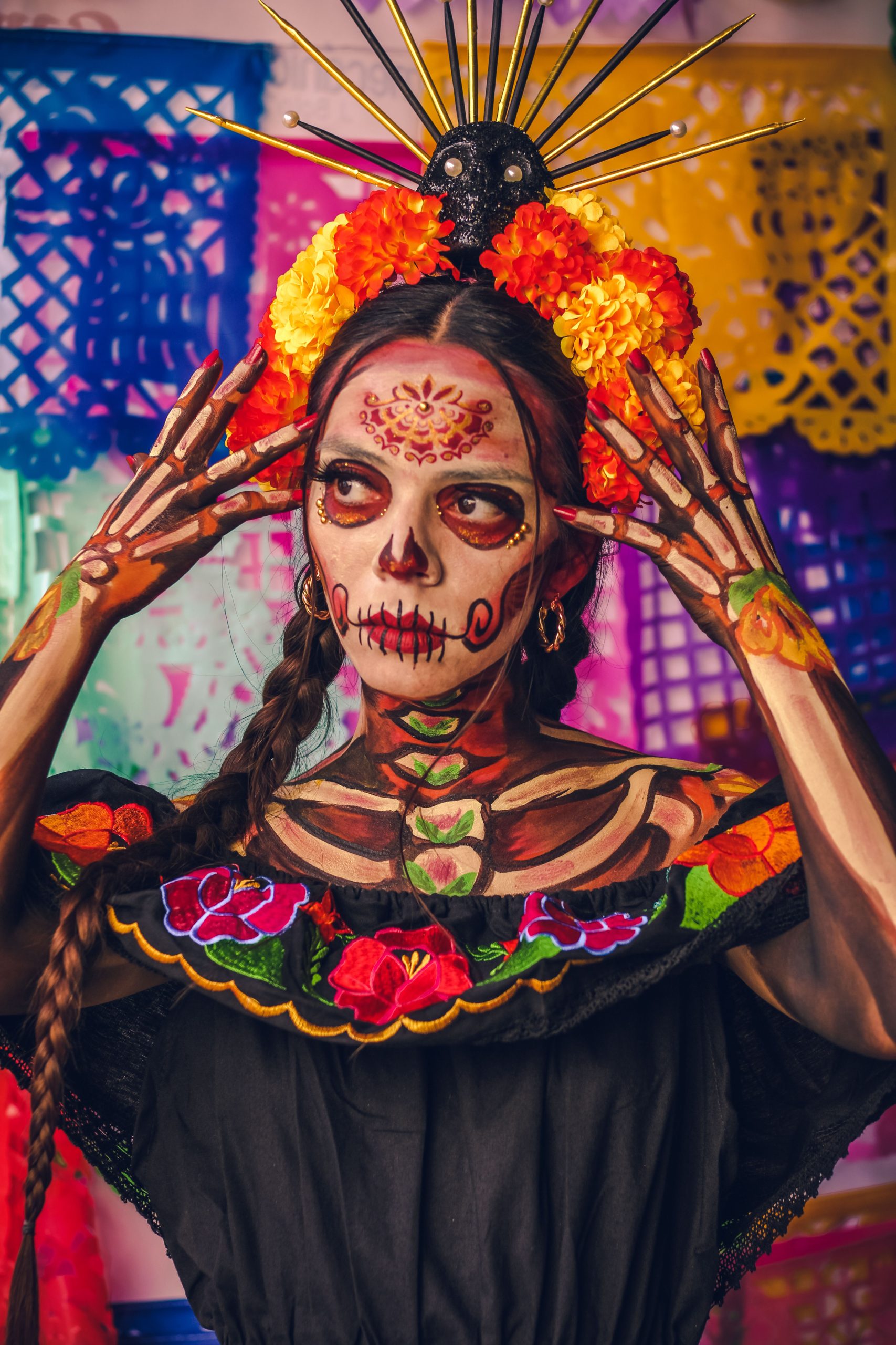 Vibrant portrait of a woman with Catrina makeup celebrating Dia de Muertos.