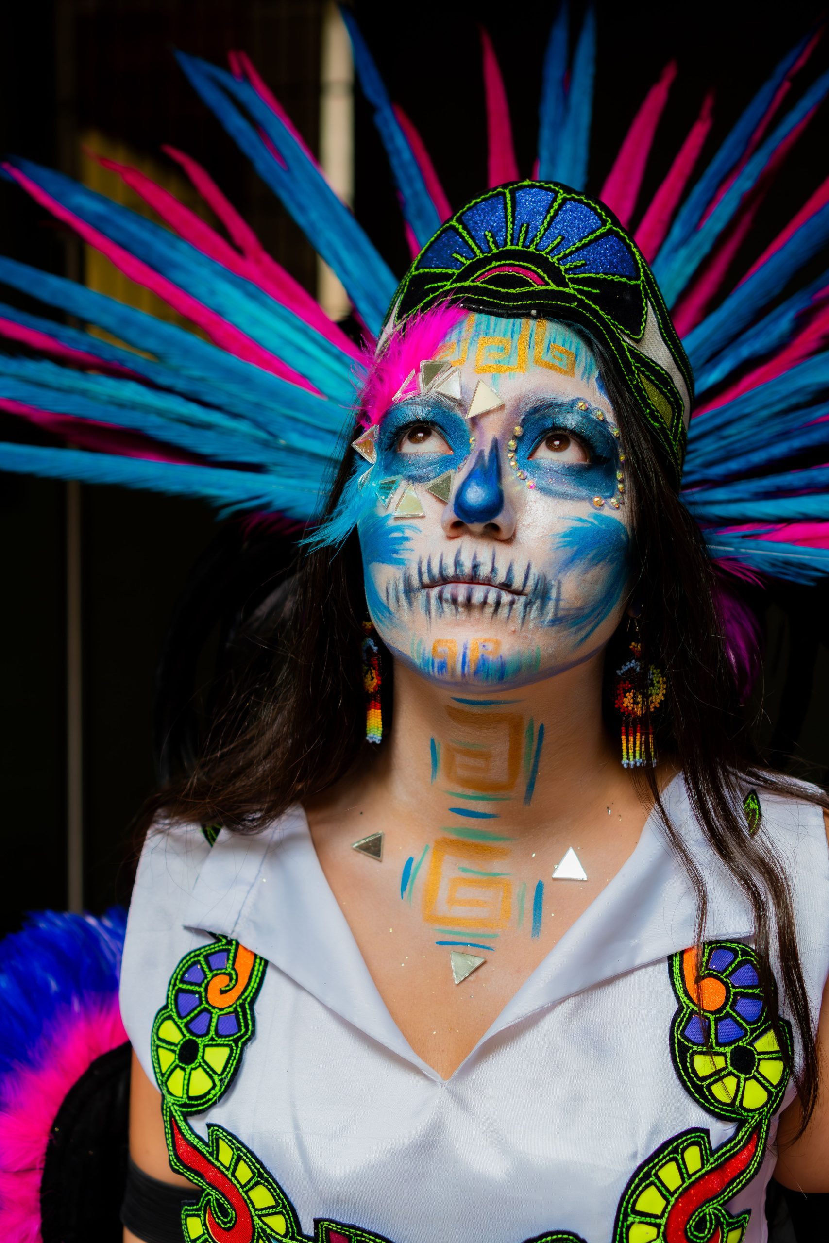 Vivid portrait of a woman in traditional Dia de los Muertos attire and makeup in Mexico City.