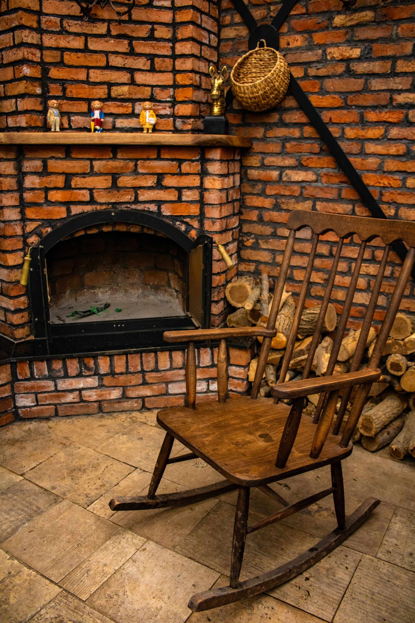 Warm and inviting indoor scene with a rustic fireplace and wooden rocking chair.