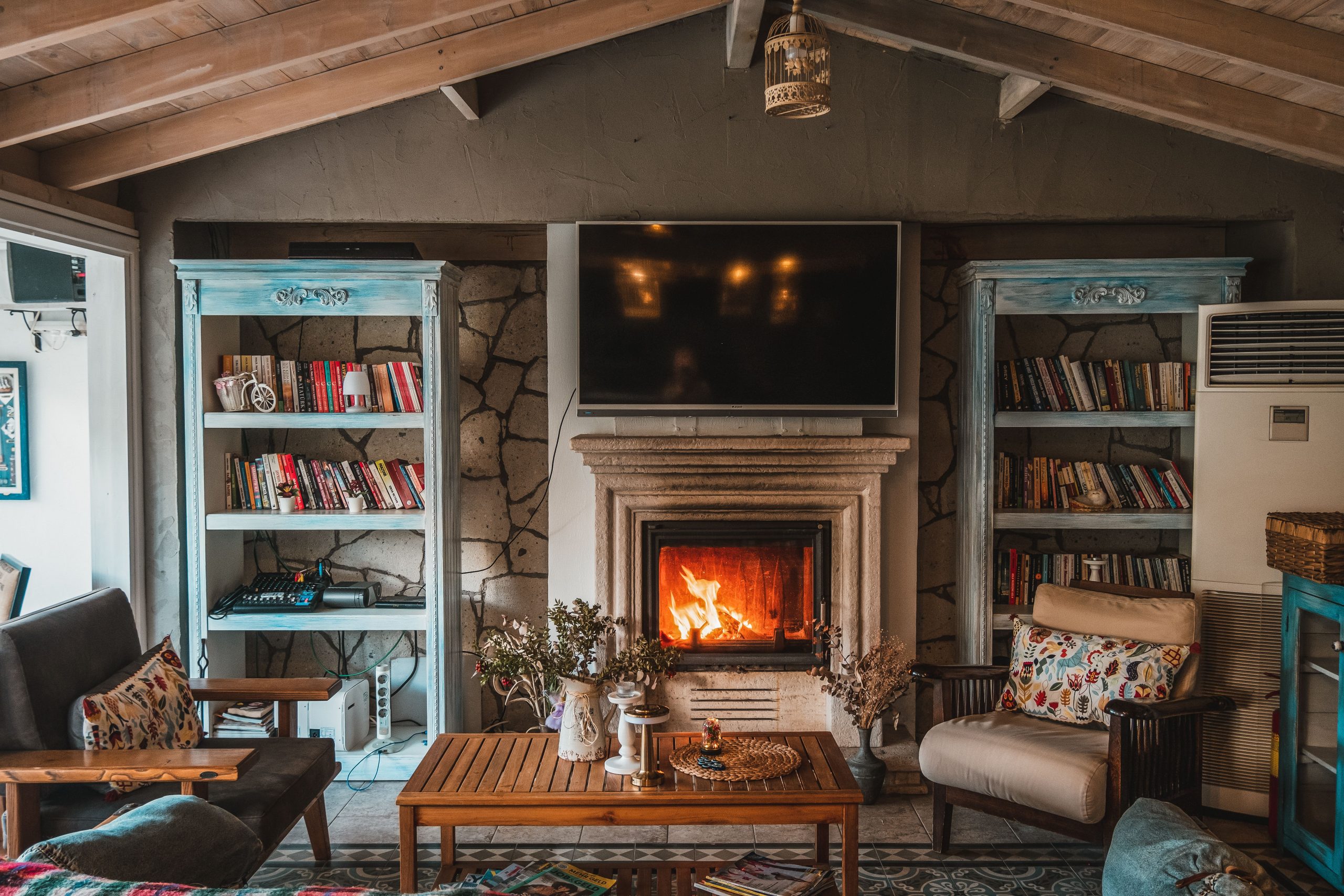 Warm and inviting living room featuring a cozy fireplace and decorative bookshelves.