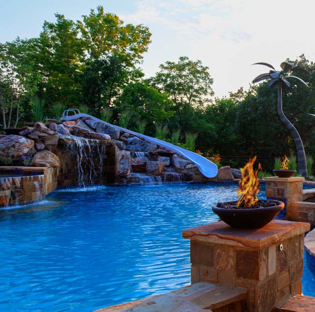 Waterfall,-fire,-and-waterslide-features-by-Backyard-by-Design-Kansas-City – Backyard by Design
