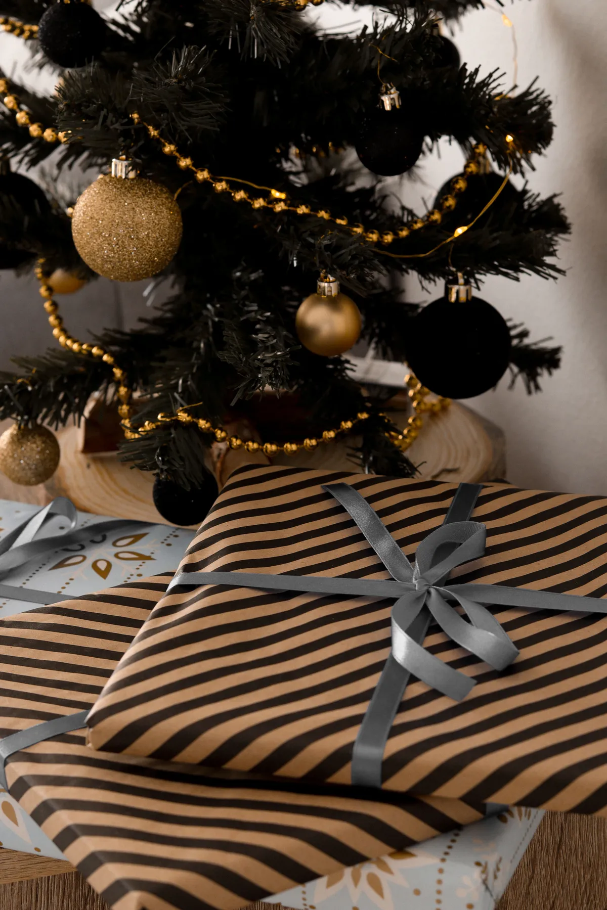 A beautifully decorated Christmas tree with elegant wrapped gifts underneath. Perfect for festive inspiration.