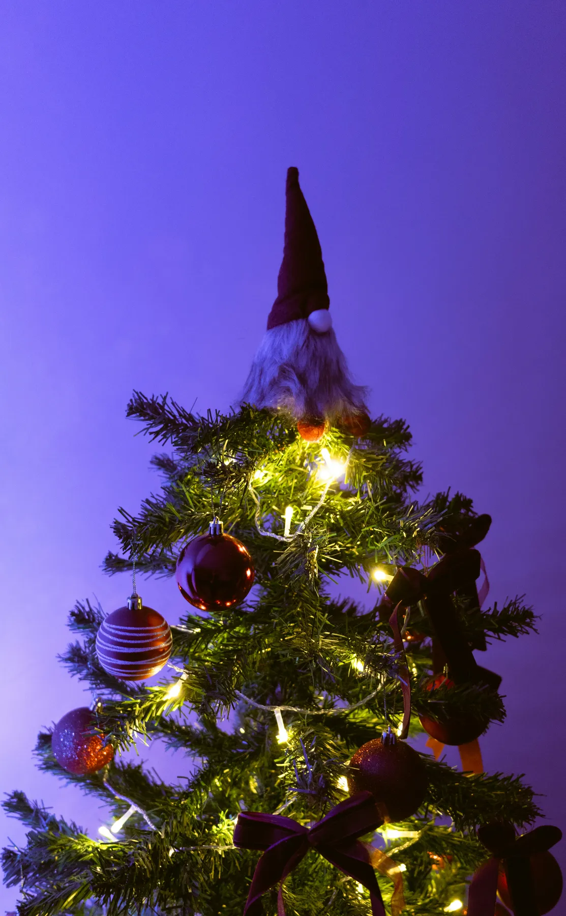 A christmas tree with a santa hat on top of it