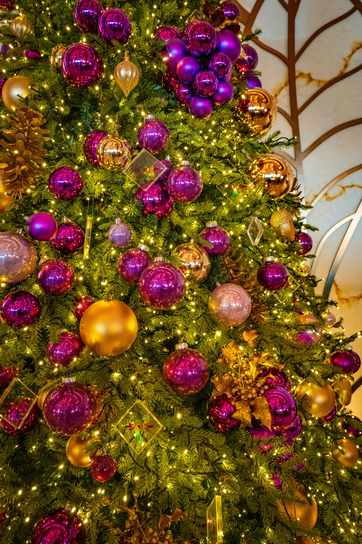 a christmas tree with purple and gold ornaments