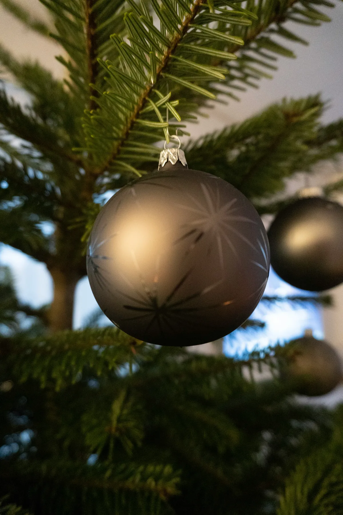 a close up of a christmas ornament on a tree