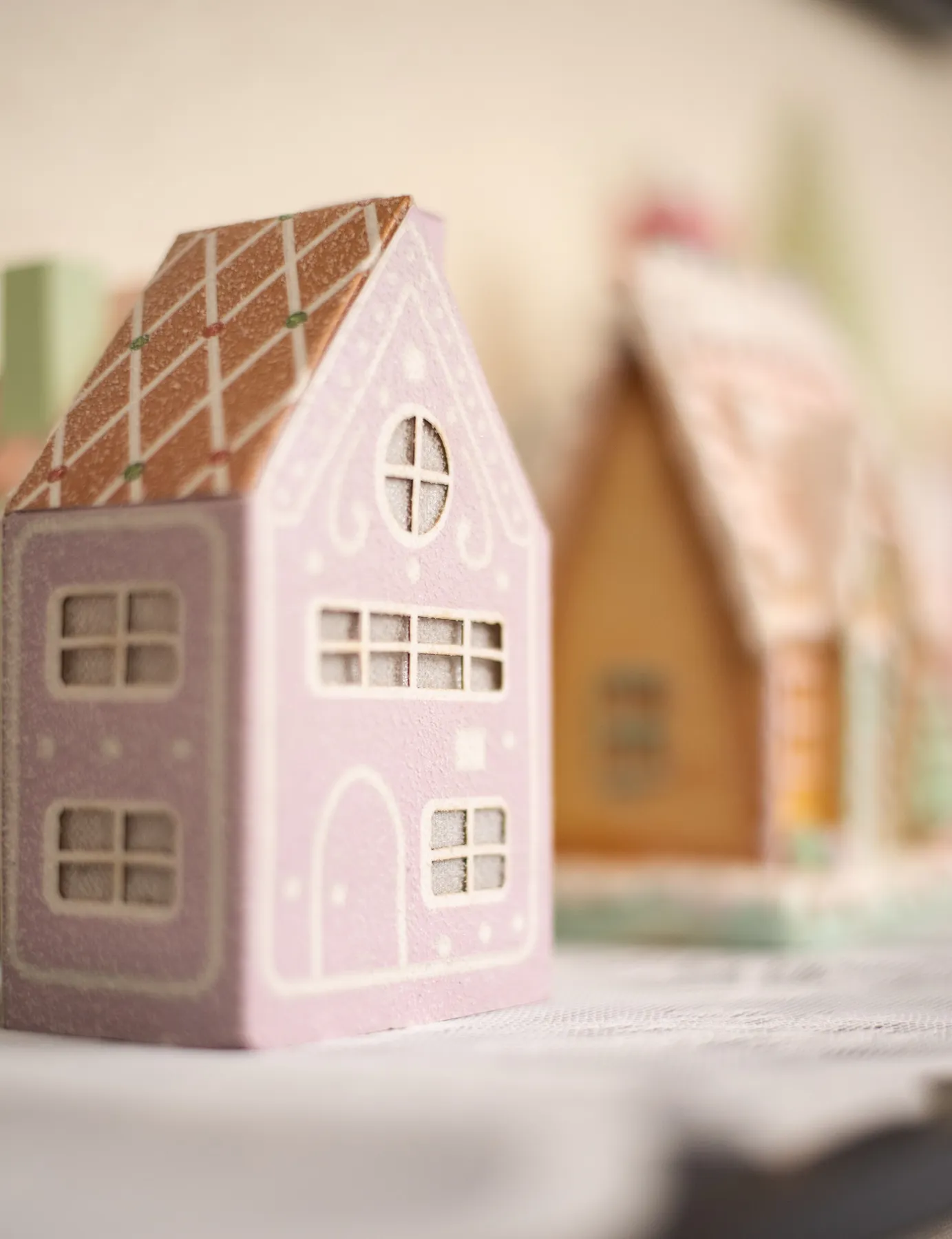 A cozy scene of pastel gingerbread houses, perfect for festive decoration and holiday spirit.