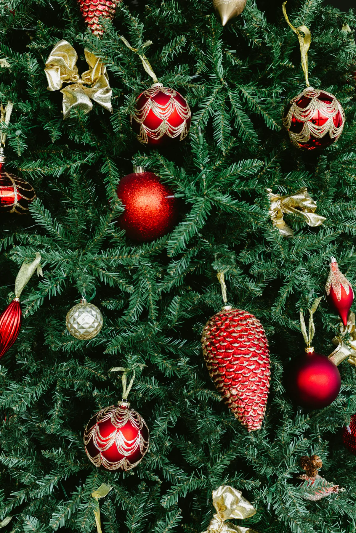 A decorated christmas tree with red and gold ornaments - Free Photo on Unsplash